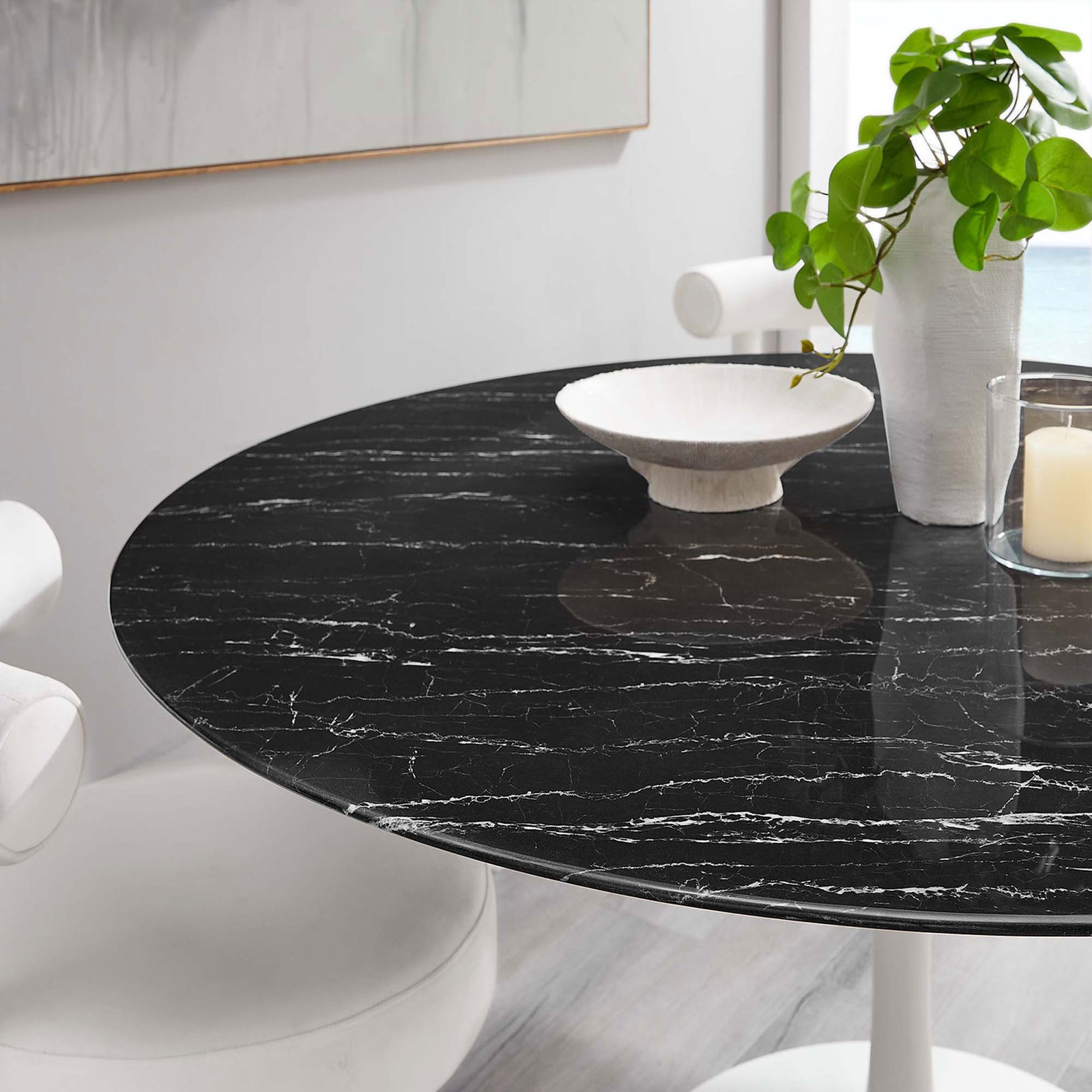 Black faux marble tabletop styled with neutral decor and candlelight for a serene dining atmosphere || EEI-5184-WHI-BLK || detail_room