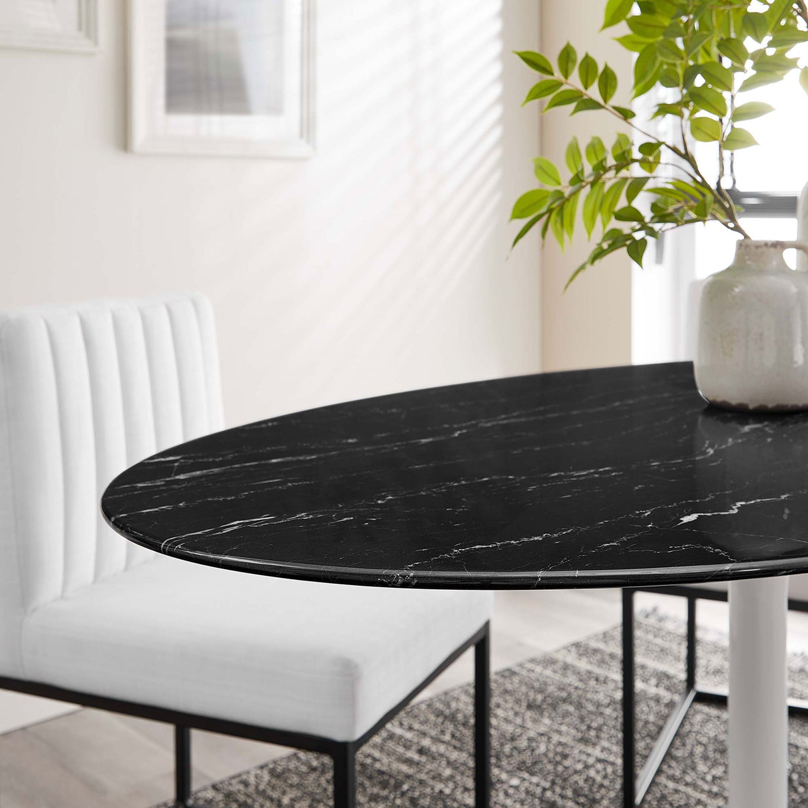 Black faux marble tabletop of the Lippa 54 in. dining table styled with modern white chairs in a bright room || EEI-5185-WHI-BLK || detail_room