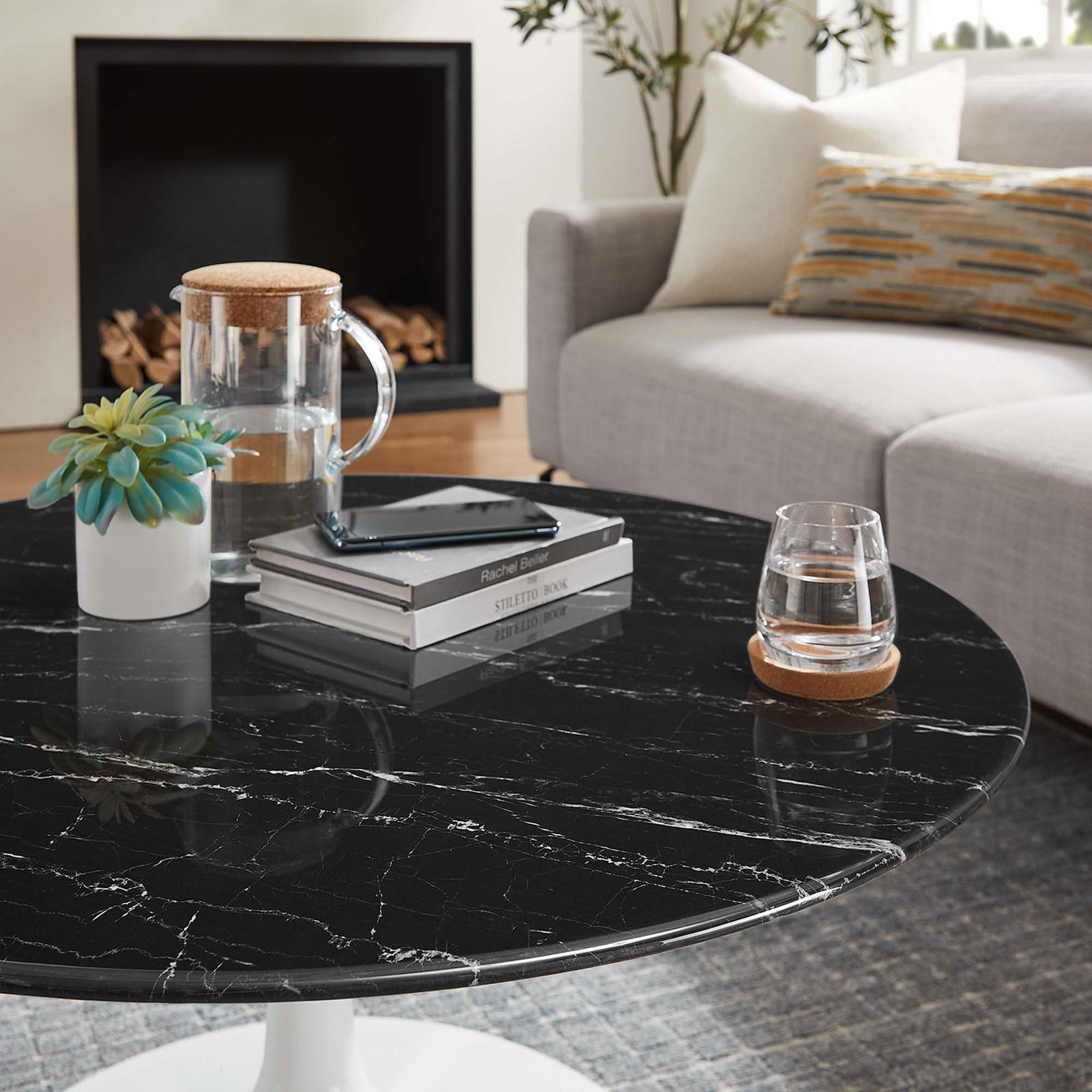 Rich black marble-look surface styled with books, glassware, and decor || EEI-5191-WHI-BLK || detail_room