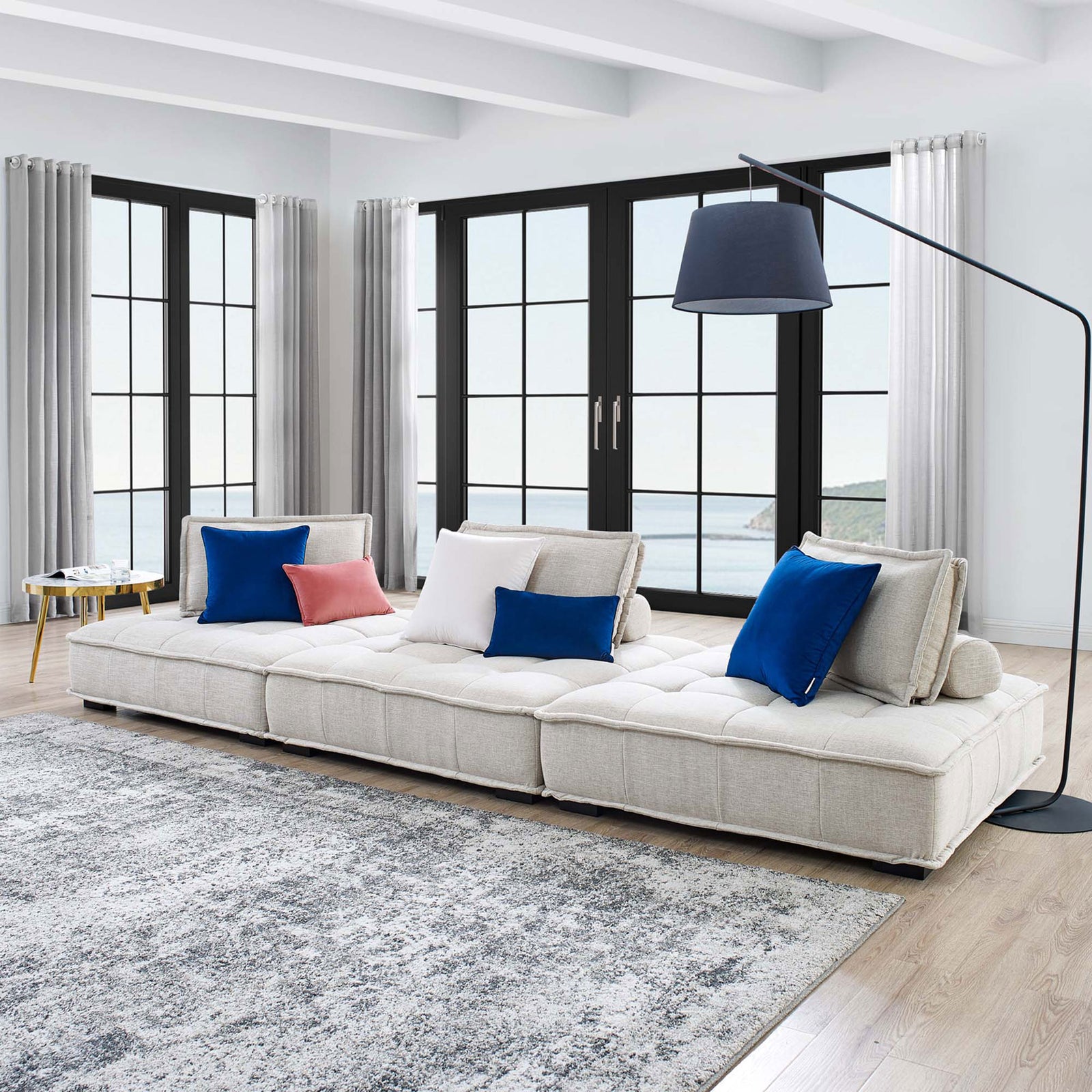 Beige Saunter tufted sofa styled in a bright coastal living room with colorful accent pillows || EEI-5206-BEI || front_angle_room
