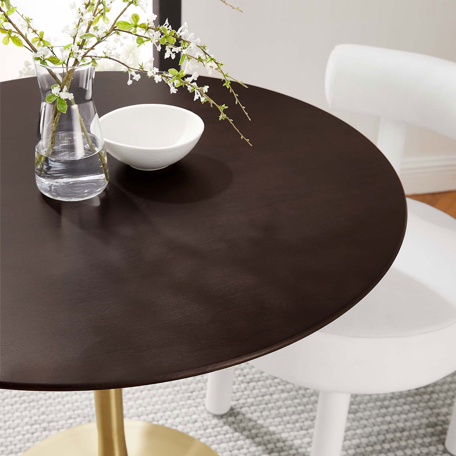 Cherry walnut tabletop styled with glass vase, bowl, and white chair for an intimate modern setting || EEI-5214-GLD-CHE || detail_room
