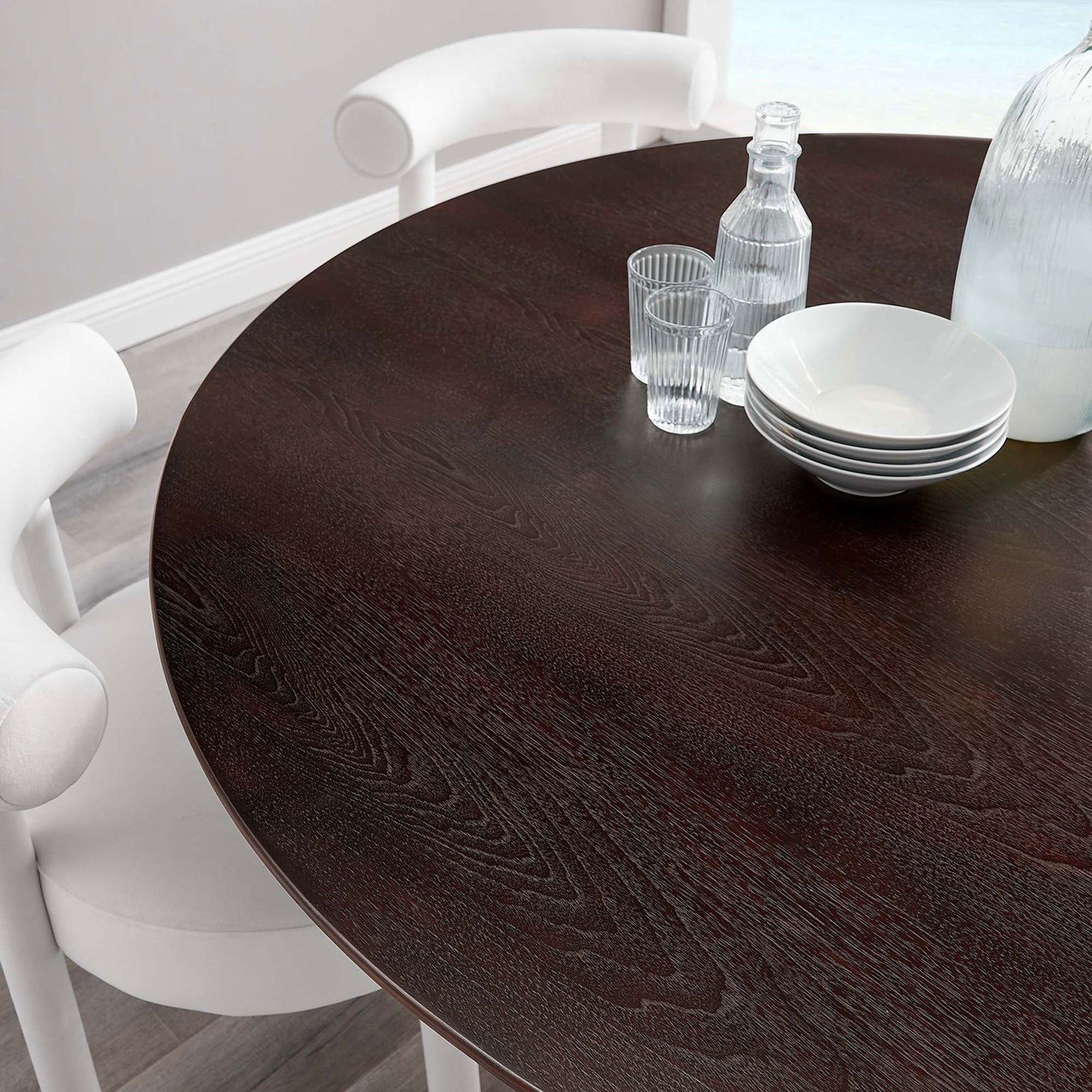 Cherry walnut tabletop styled with glassware and white chairs for a relaxed coastal dining atmosphere || EEI-5232-GLD-CHE || detail_room