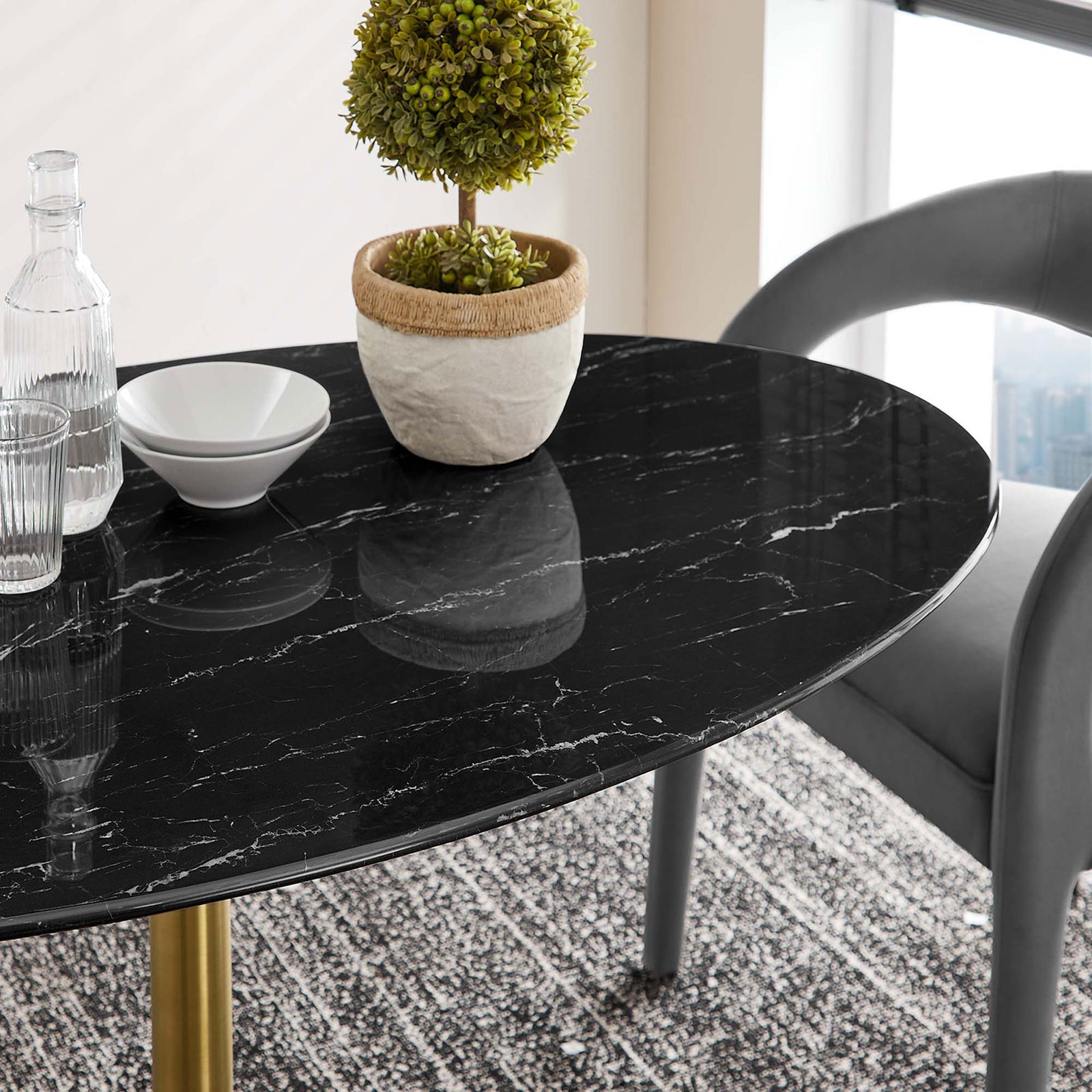 Glossy black faux marble tabletop with soft gray chairs and decor in a cozy dining setting. || EEI-5242-GLD-BLK || detail_room