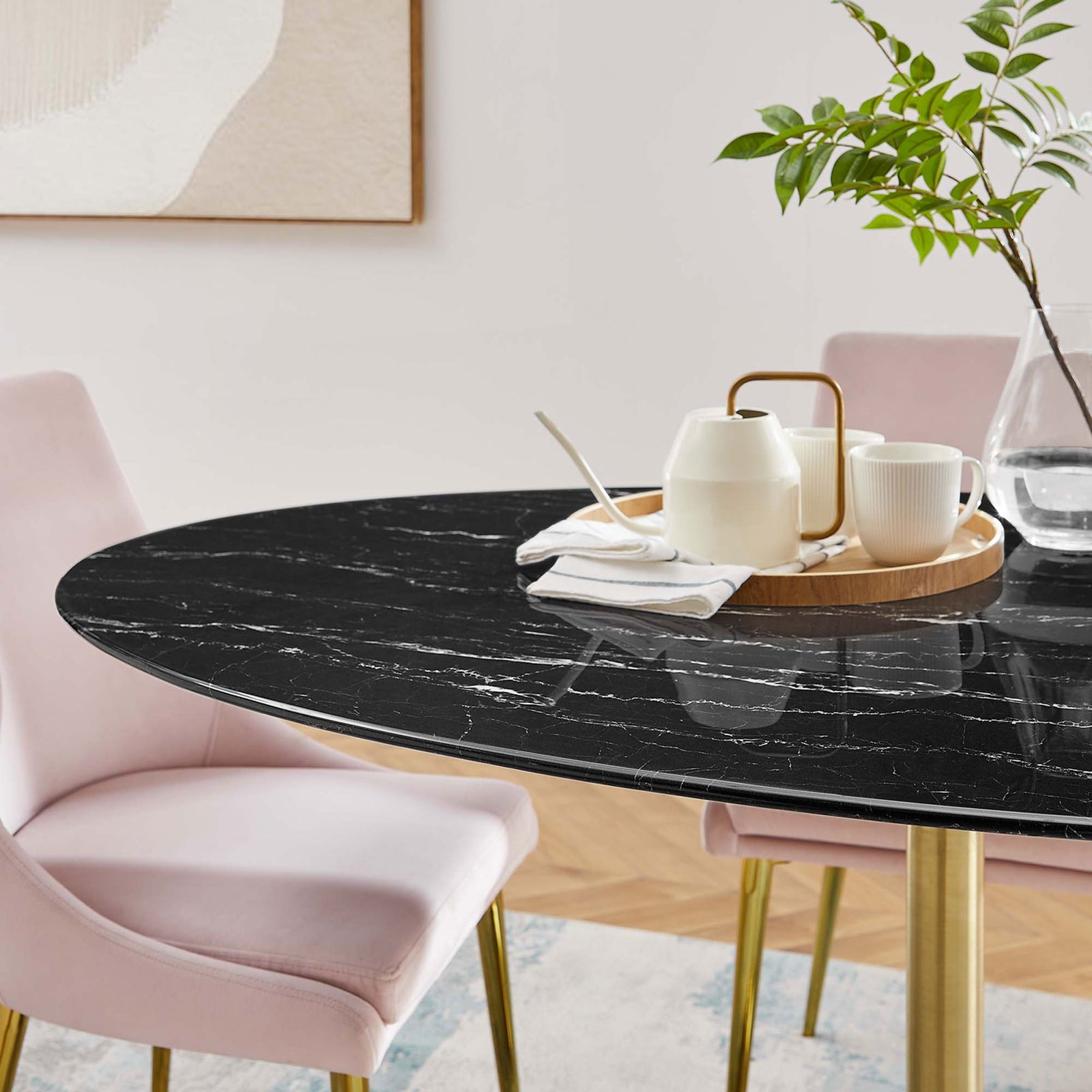Polished black faux marble tabletop styled with serveware and greenery in a contemporary dining space. || EEI-5243-GLD-BLK || detail_room
