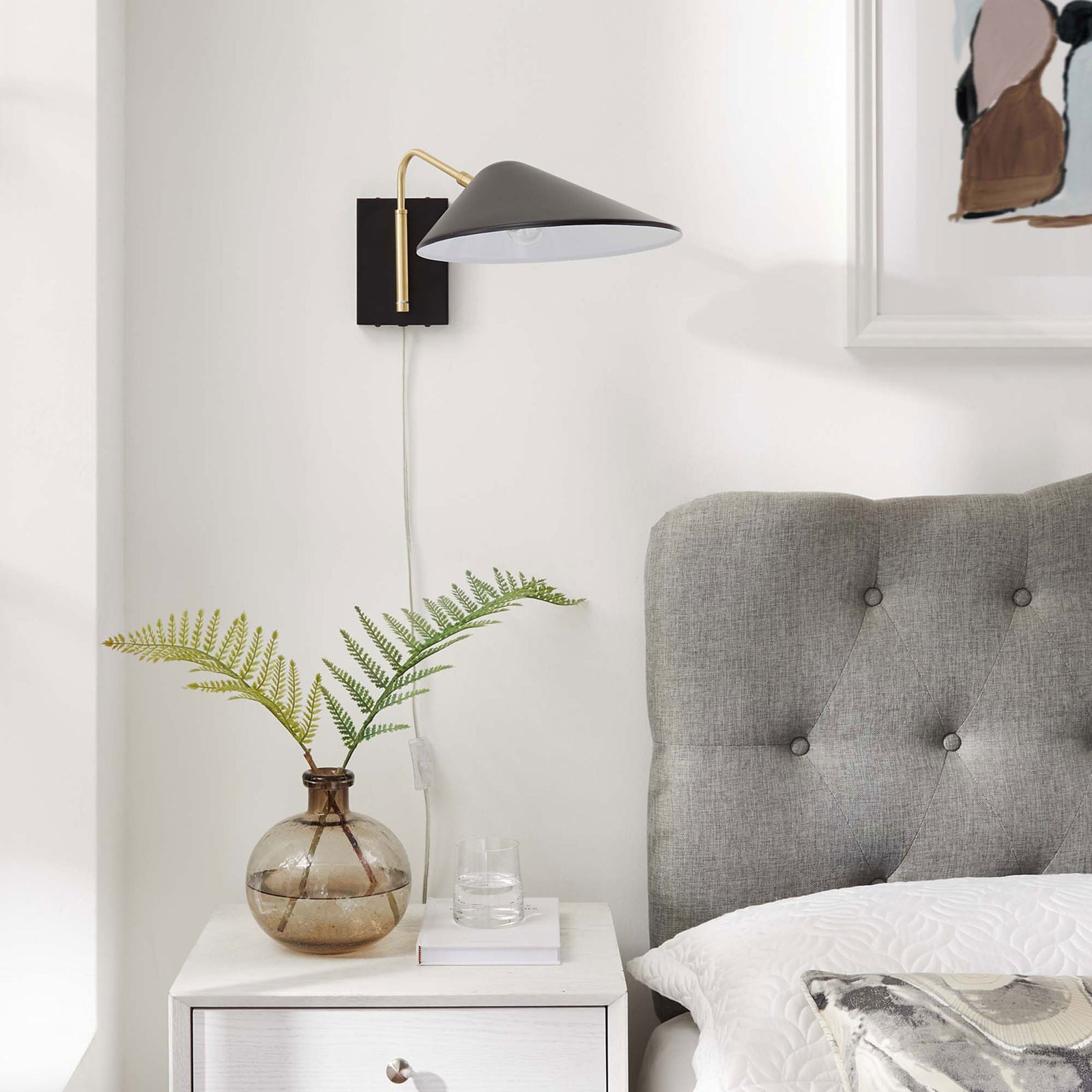 Black Journey sconce accents a neutral bedroom with modern contrast above the nightstand. || EEI-5296-BLK || front_room