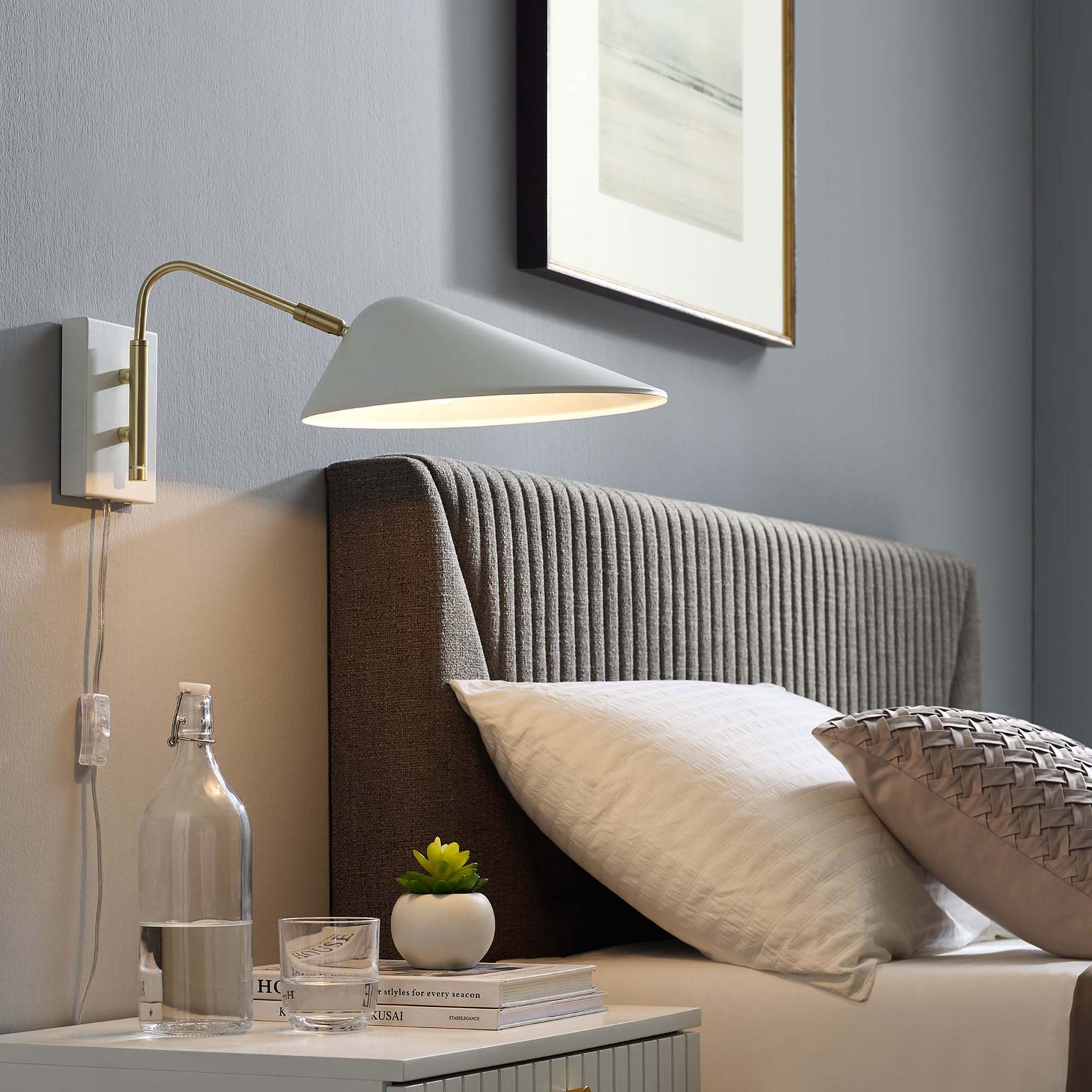 Glowing white swing arm sconce brightens a contemporary bedroom with warm focused light. || EEI-5296-WHI || front_angle_on_room