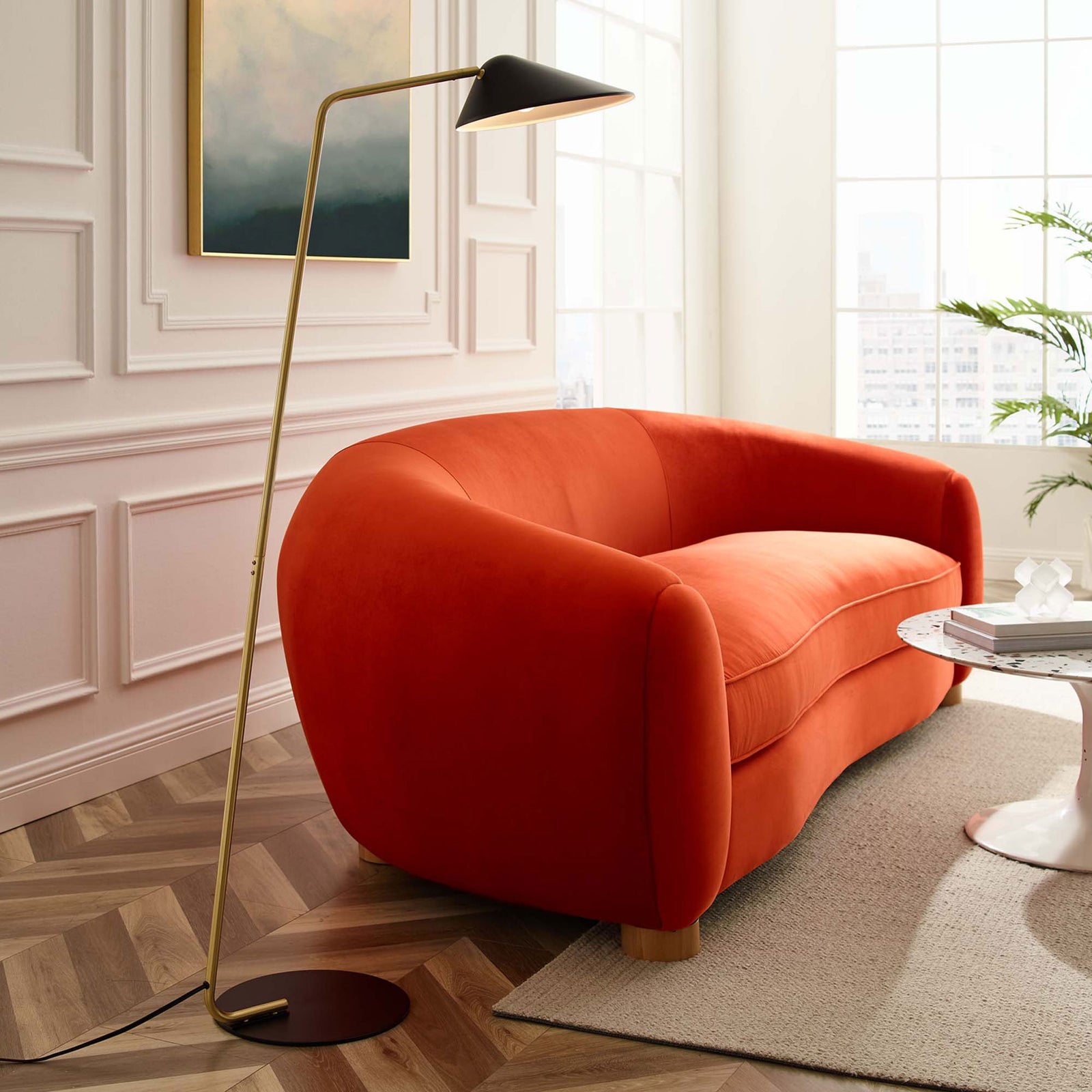 Contemporary floor lamp with slender brass pole and black shade illuminates a stylish lounge seating area || EEI-5298-BLK || side_room