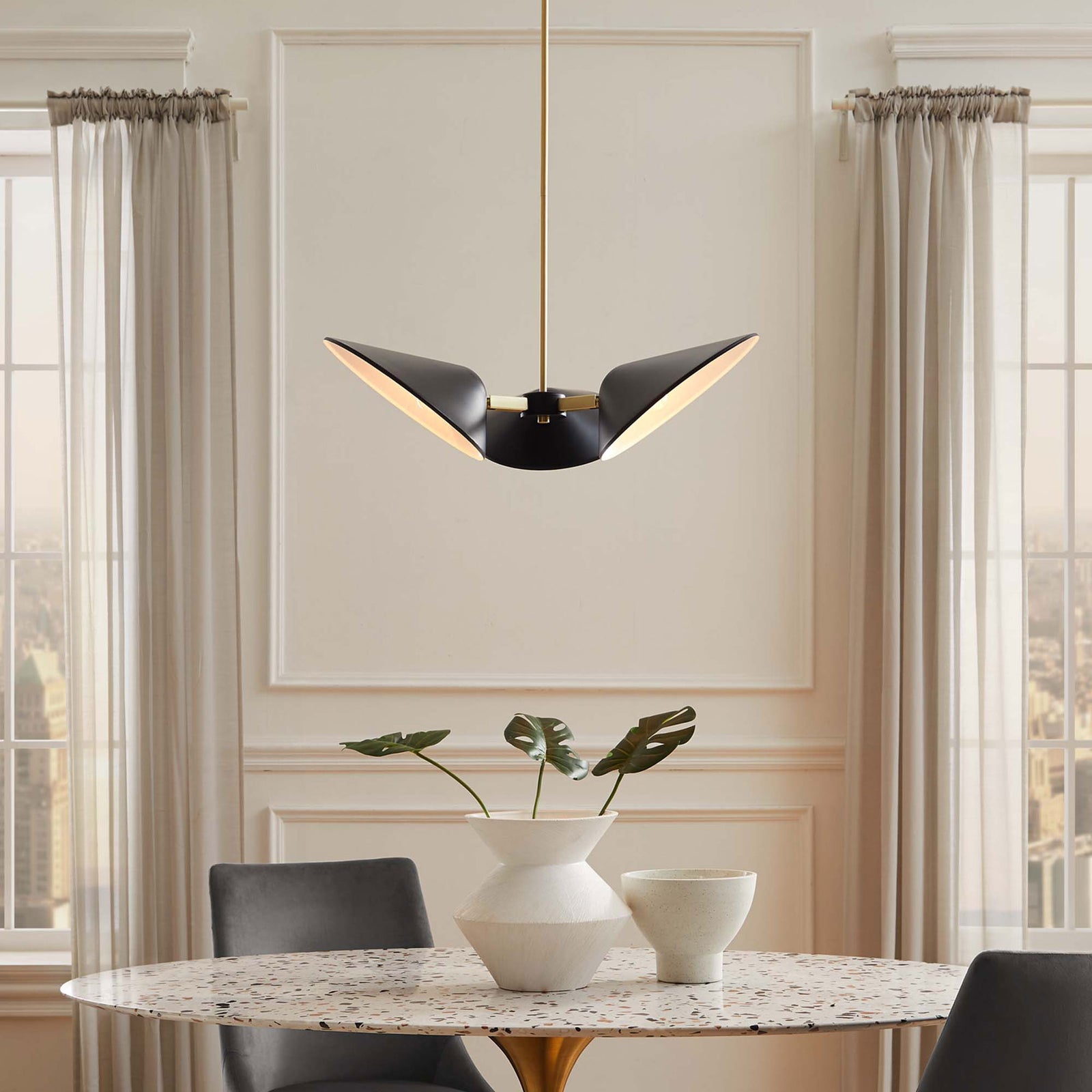 Warm, inviting illumination from a modern 3-light pendant in a dining room || EEI-5299-BLK || front_on_room