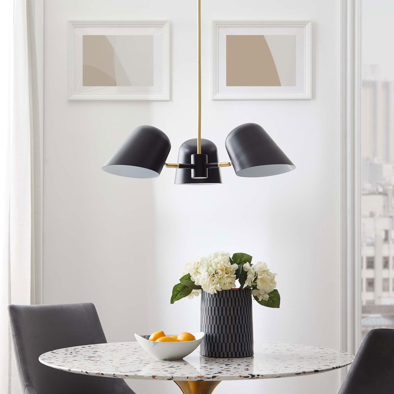 Modern three-light pendant lends refined contrast above the table with black shades and brass accents || EEI-5301-BLK || front_room