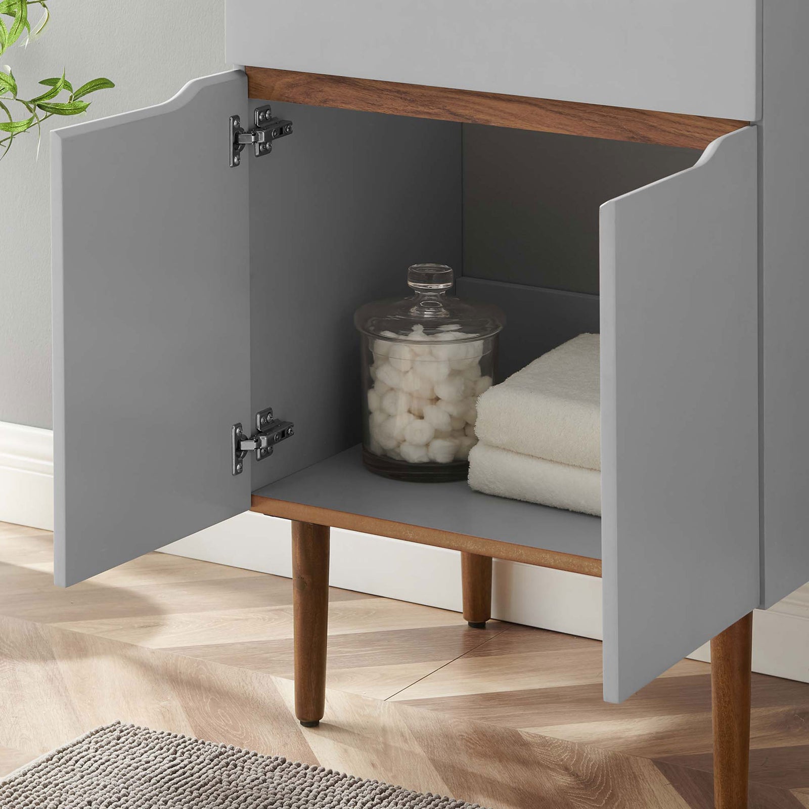 Open cabinet stores towels and jars to keep bath necessities neatly organized || EEI-5357-GRY-BLK || storage_open_room