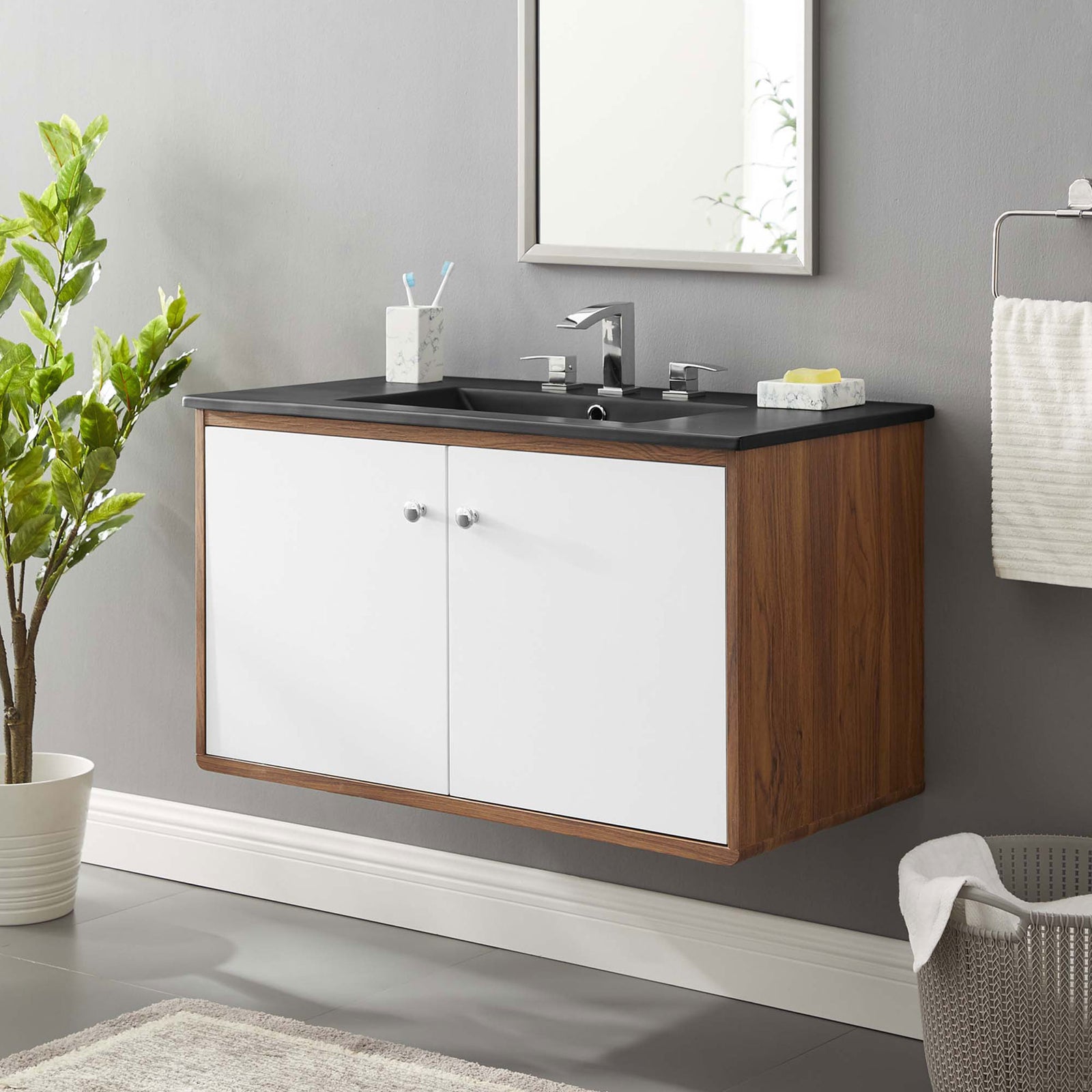 Floating wall-mount vanity with black countertop and white doors elevates a modern bathroom || EEI-5393-WAL-BLK || front_angle_room