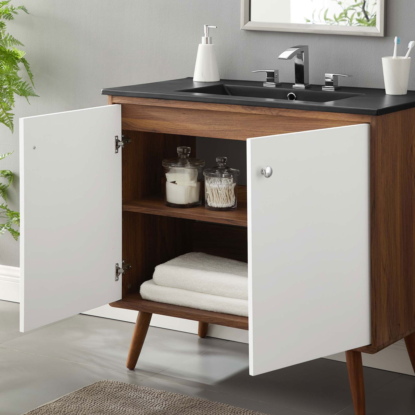 Doors open to reveal easy-access storage and a deep basin for everyday routines || EEI-5394-WAL-BLK || storage_open_room