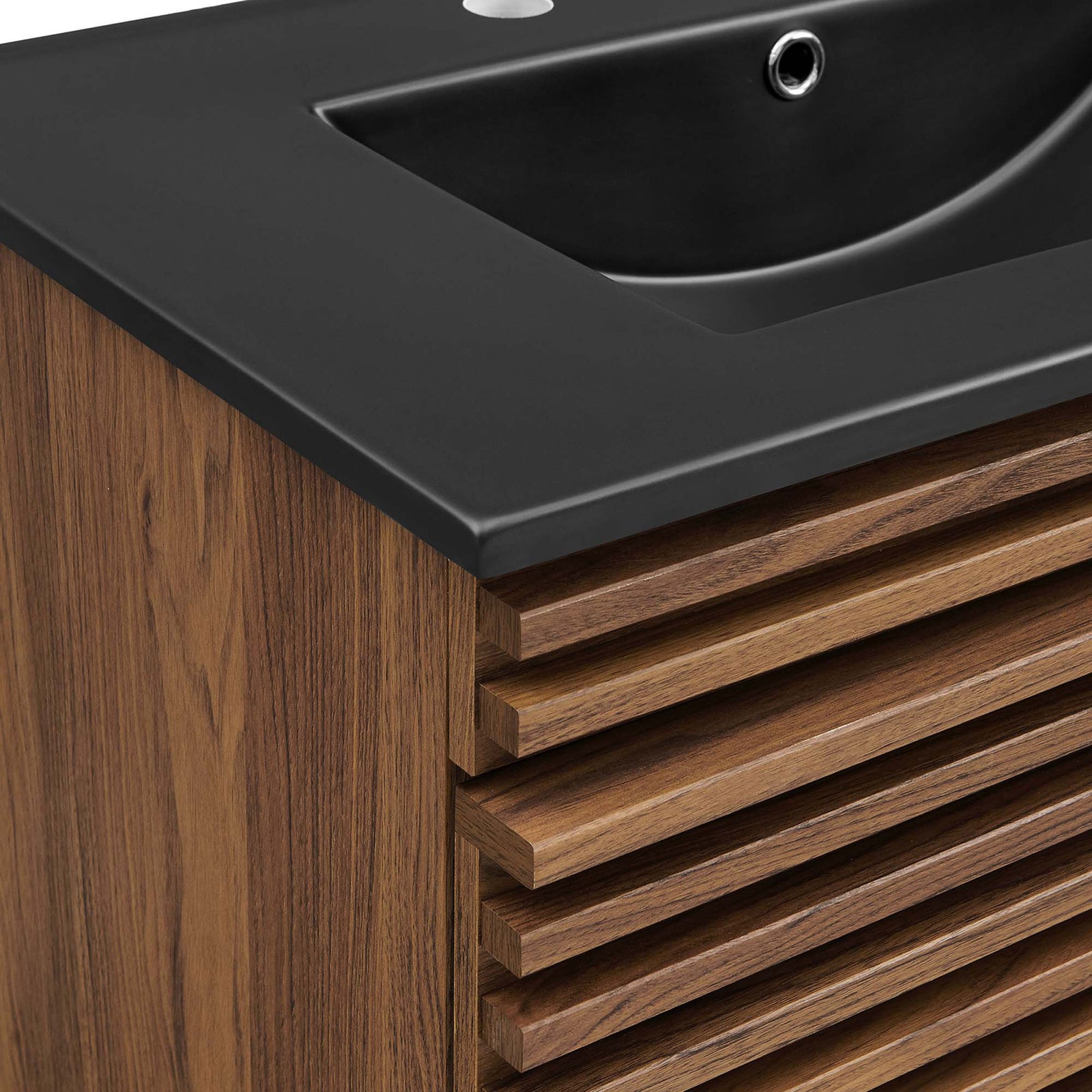 Fine wood grain and stepped drawer fronts meet a smooth, curved basin edge. || EEI-5417-WAL-BLK || detail_studio