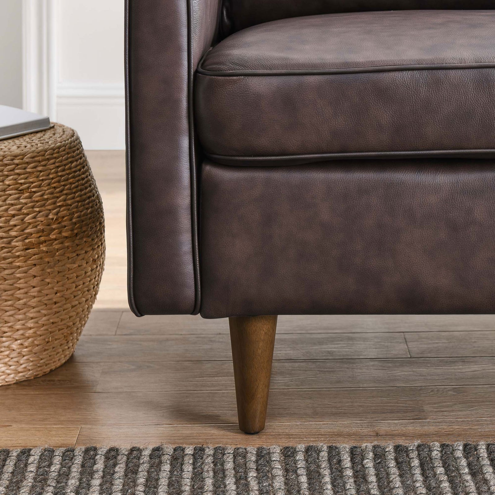 Tapered walnut leg and tailored base detail on the brown genuine leather armchair || EEI-5555-BRN || leg_room