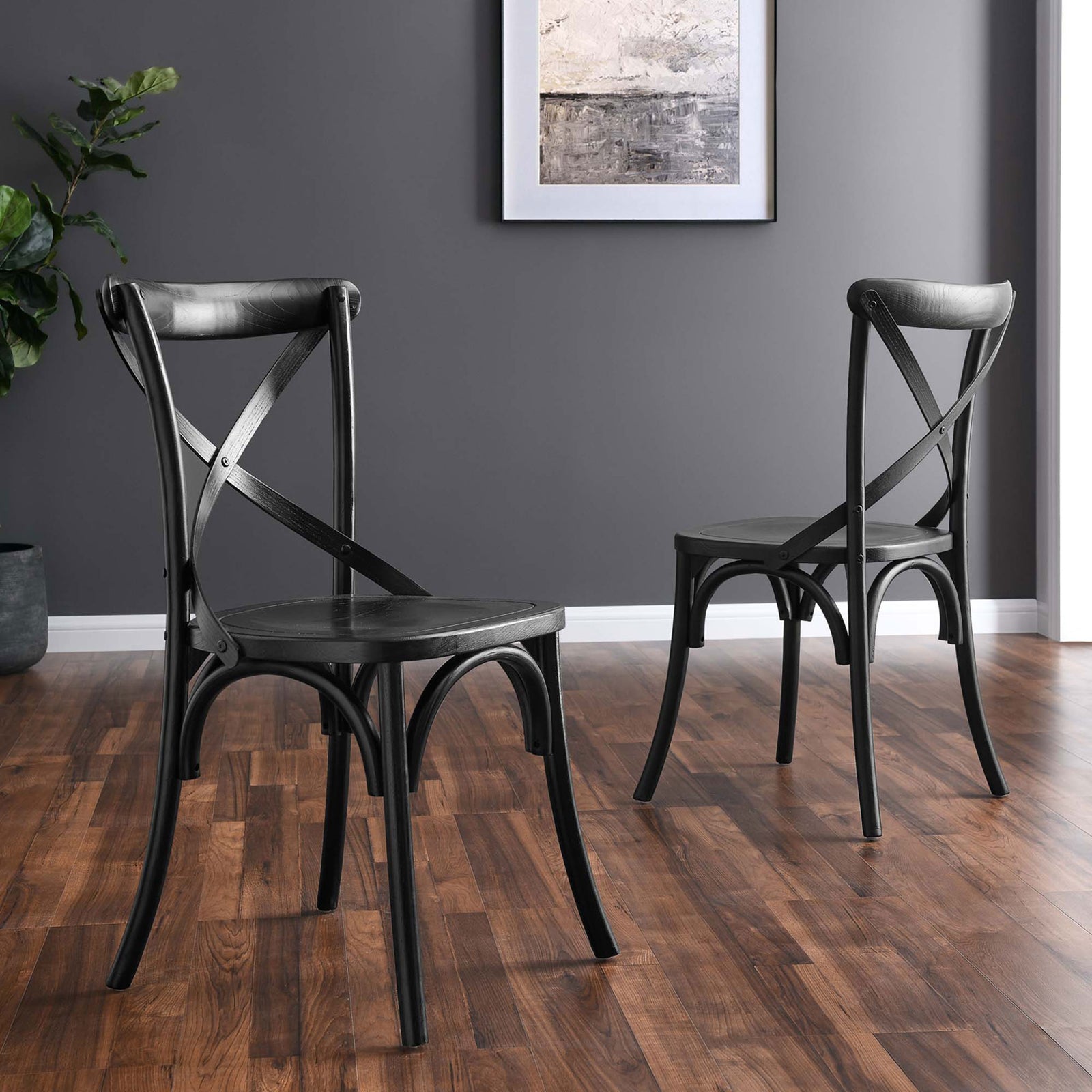 Two black X-back dining chairs with curved legs arranged in a warm wood dining room || EEI-5564-BLK || front_angle_room
