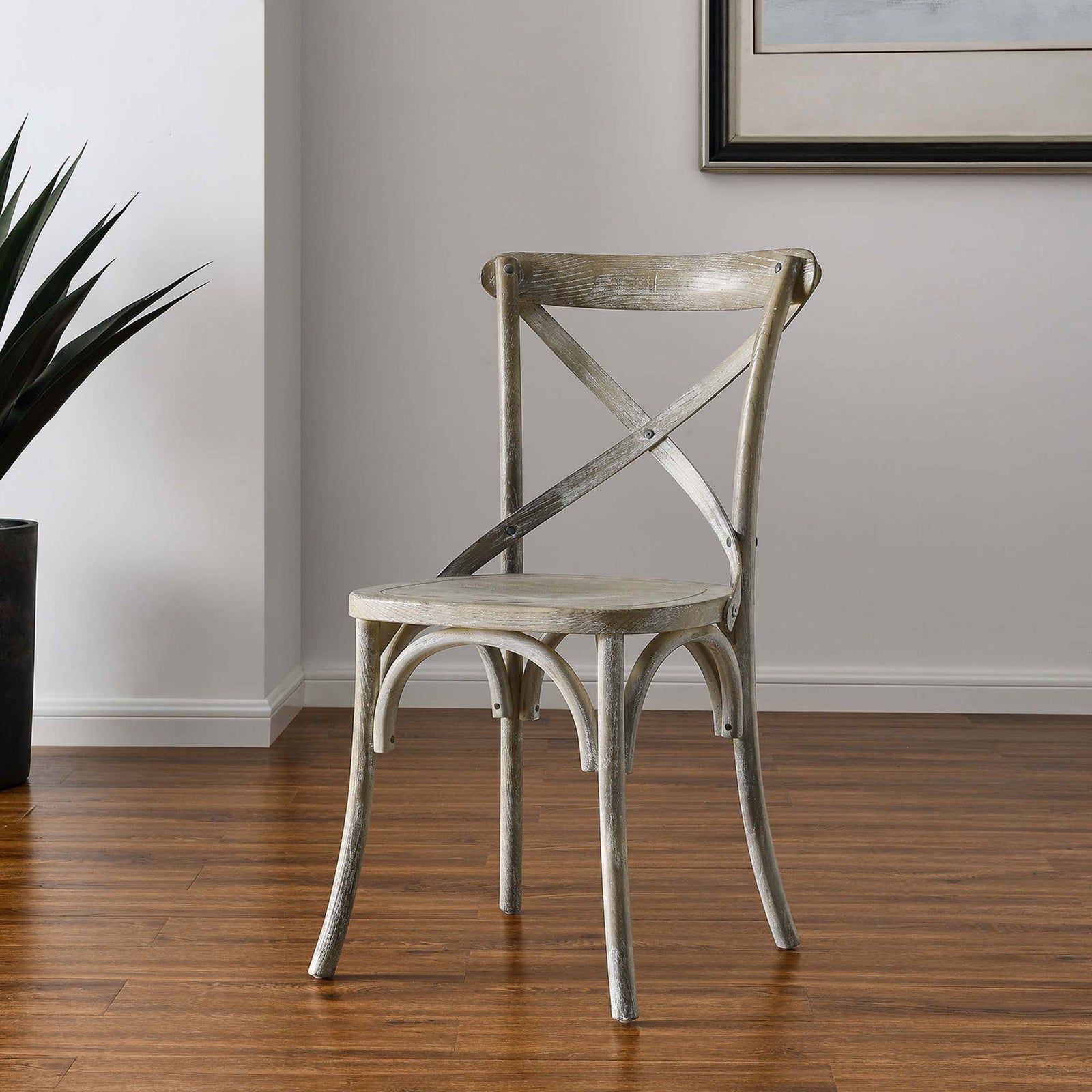 Gray farmhouse dining chair styled in a bright room with wood floors and contemporary wall art || EEI-5564-GRY || front_angle_room