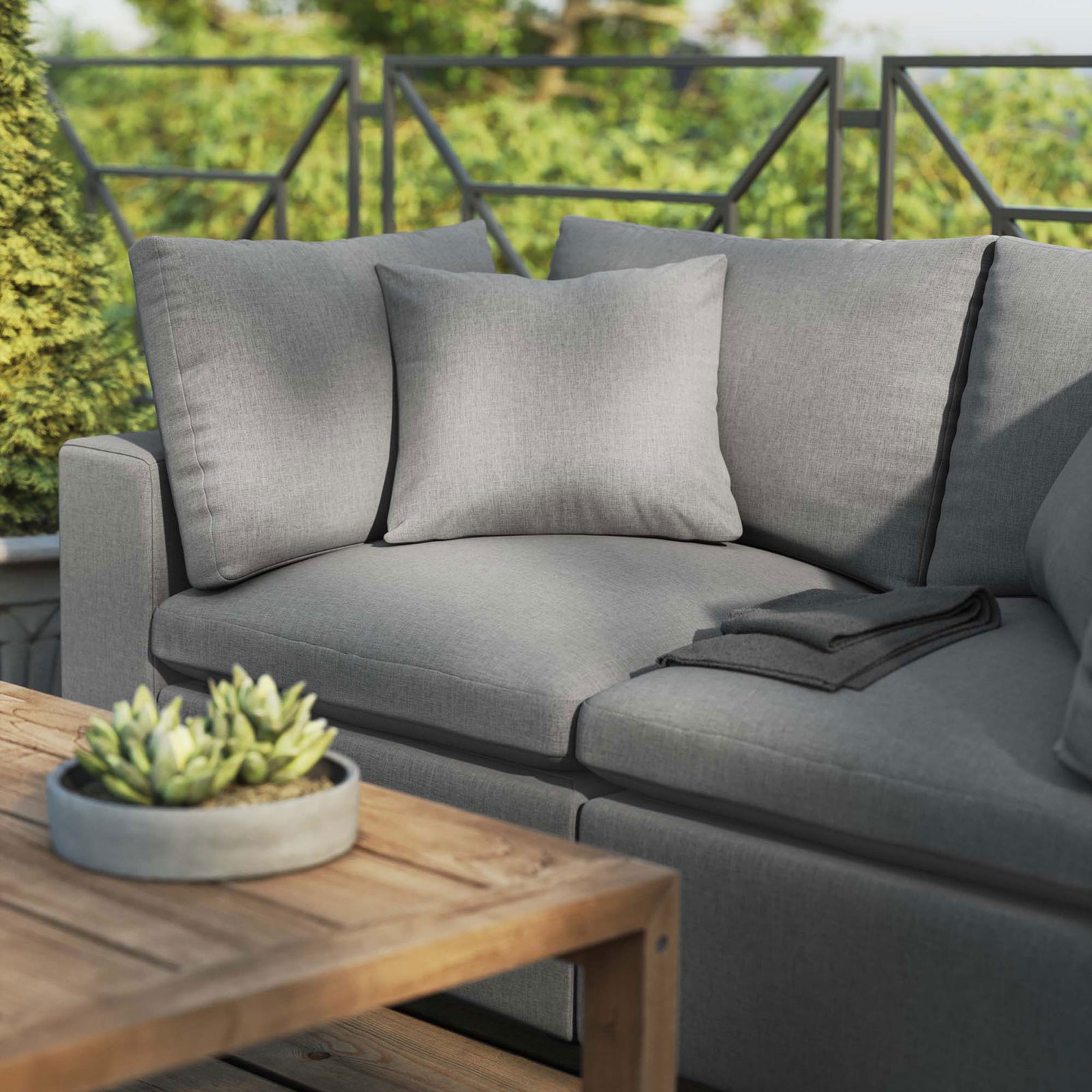 Charcoal patio loveseat styled with a wood coffee table and succulent planter on a sunny deck || EEI-5576-CHA || detail_room