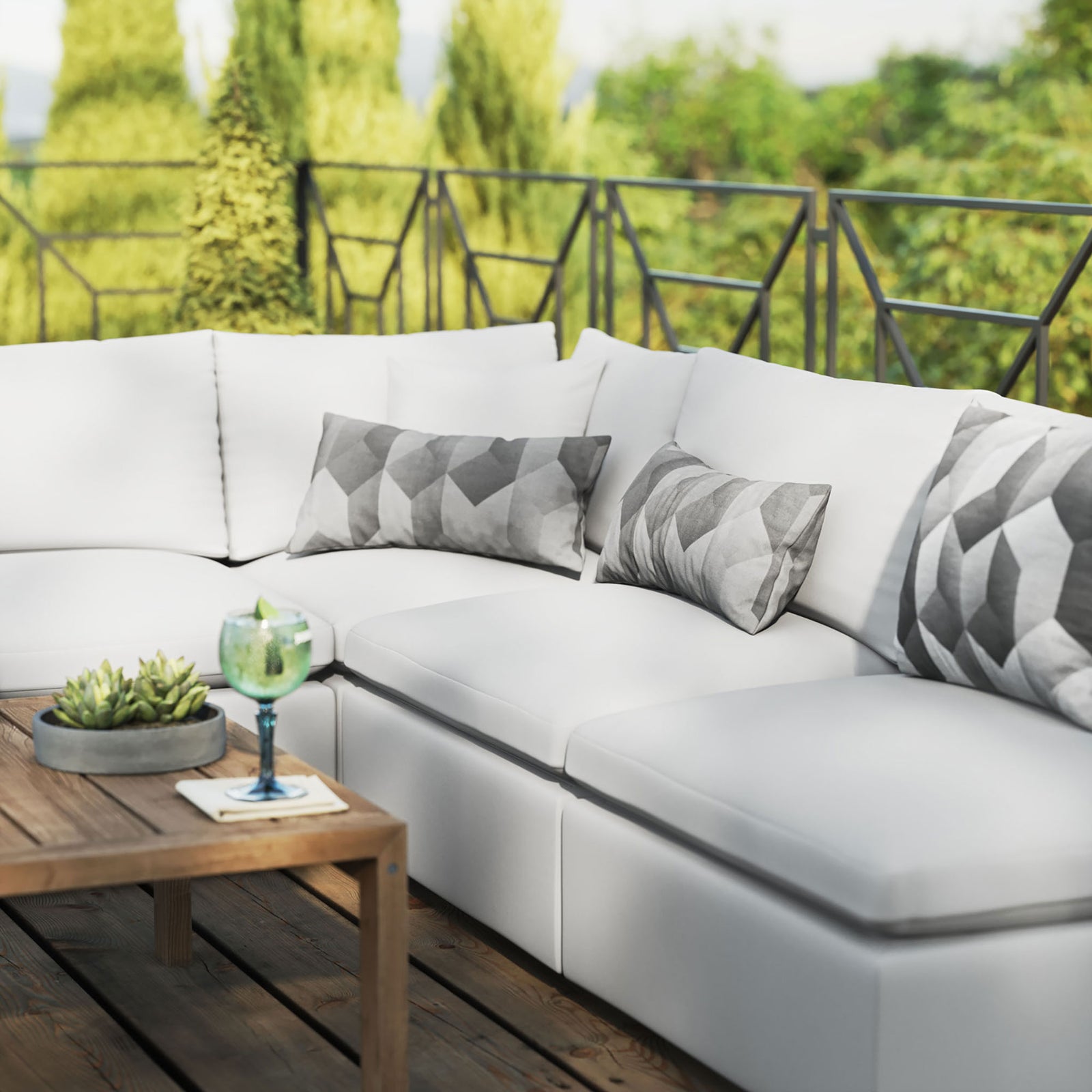 White outdoor sectional styled with geometric pillows and decor on a wood deck setting. || EEI-5587-WHI || detail_room