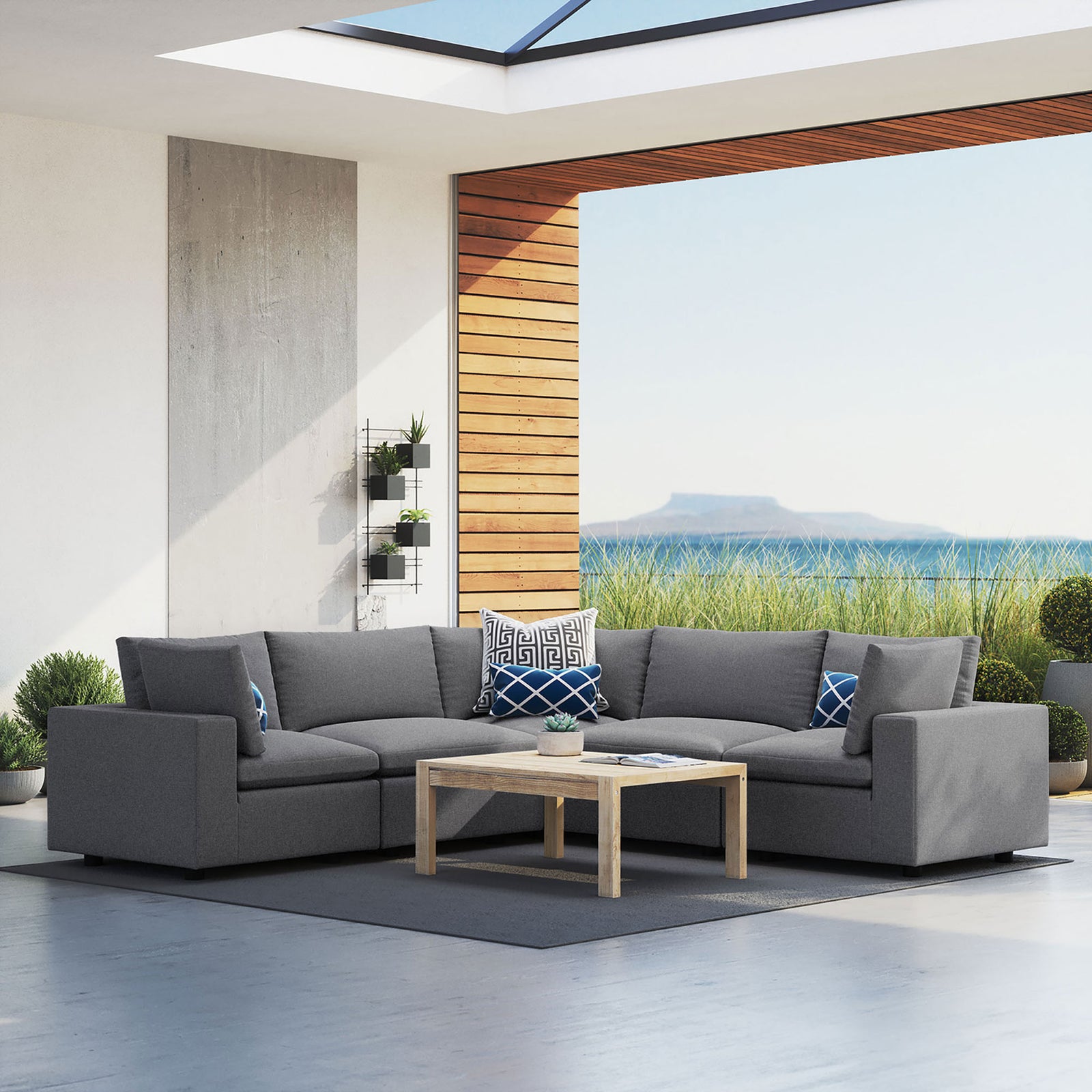 Gray Commix Sunbrella outdoor sectional creating a spacious lounge area with coastal views and contemporary decor. || EEI-5590-SLA || front_angle_room