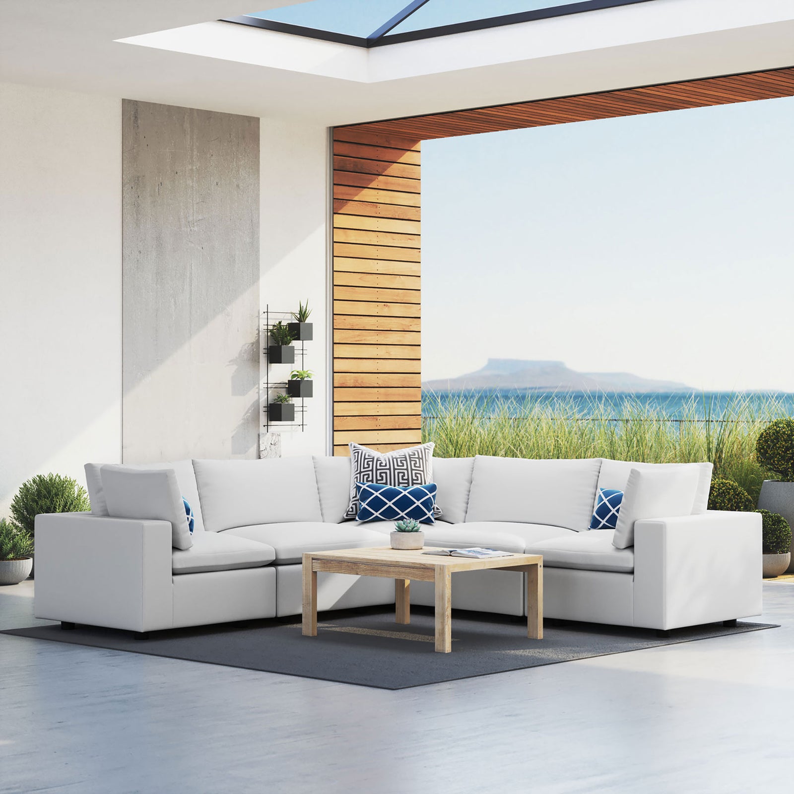 White Commix Sunbrella outdoor sectional defining a bright open-air lounge with modern architecture and greenery. || EEI-5590-WHI || front_angle_room