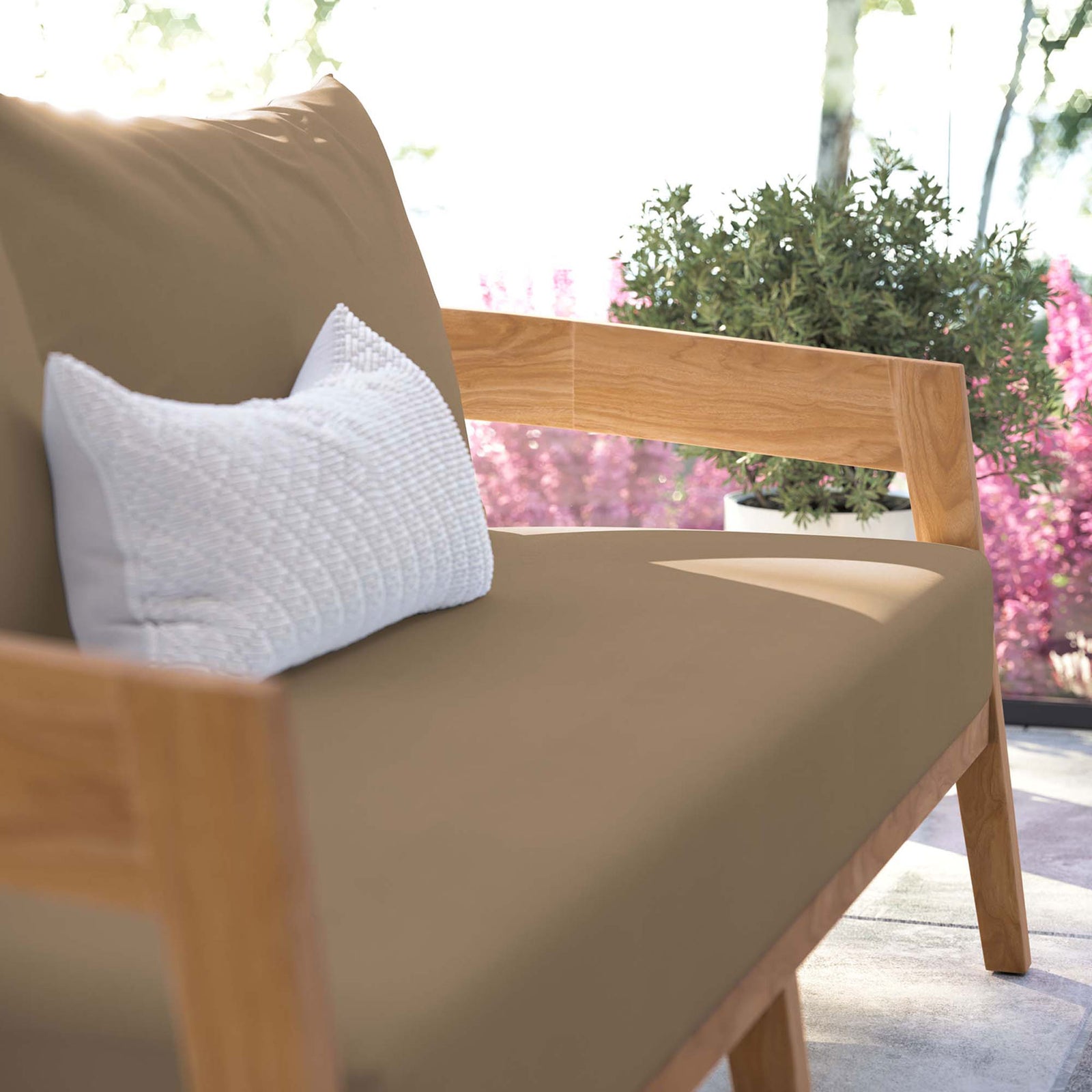 Light brown seat and accent pillow turn this teak outdoor loveseat into a relaxing retreat || EEI-5601-NAT-LBR || detail_room