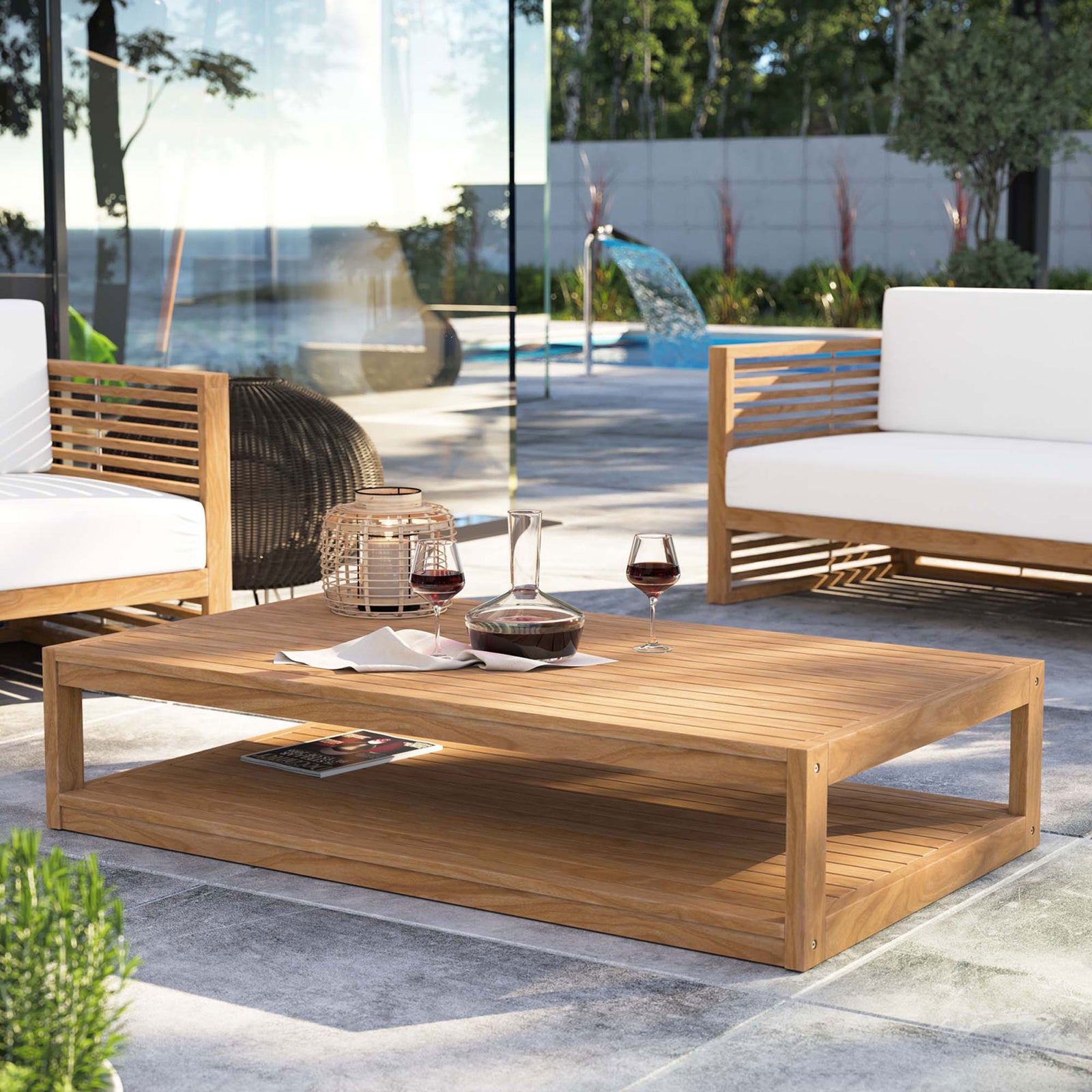 Carlsbad teak coffee table anchoring a modern outdoor lounge seating area by the pool || EEI-5608-NAT || front_angle_room