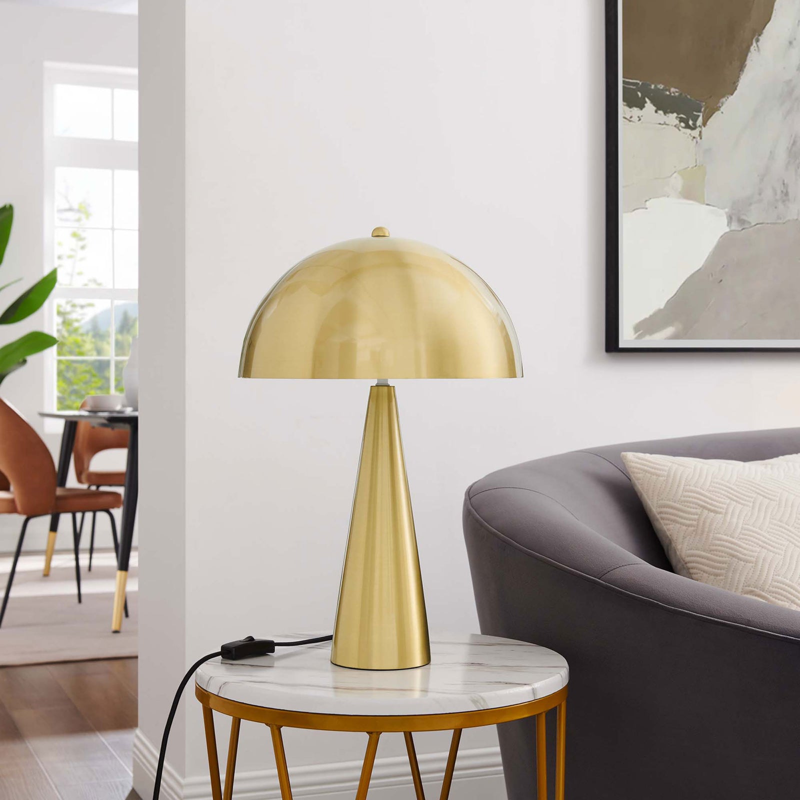 Satin brass Selena lamp styled on a marble-topped side table beside a contemporary sofa || EEI-5624-SBR || front_room
