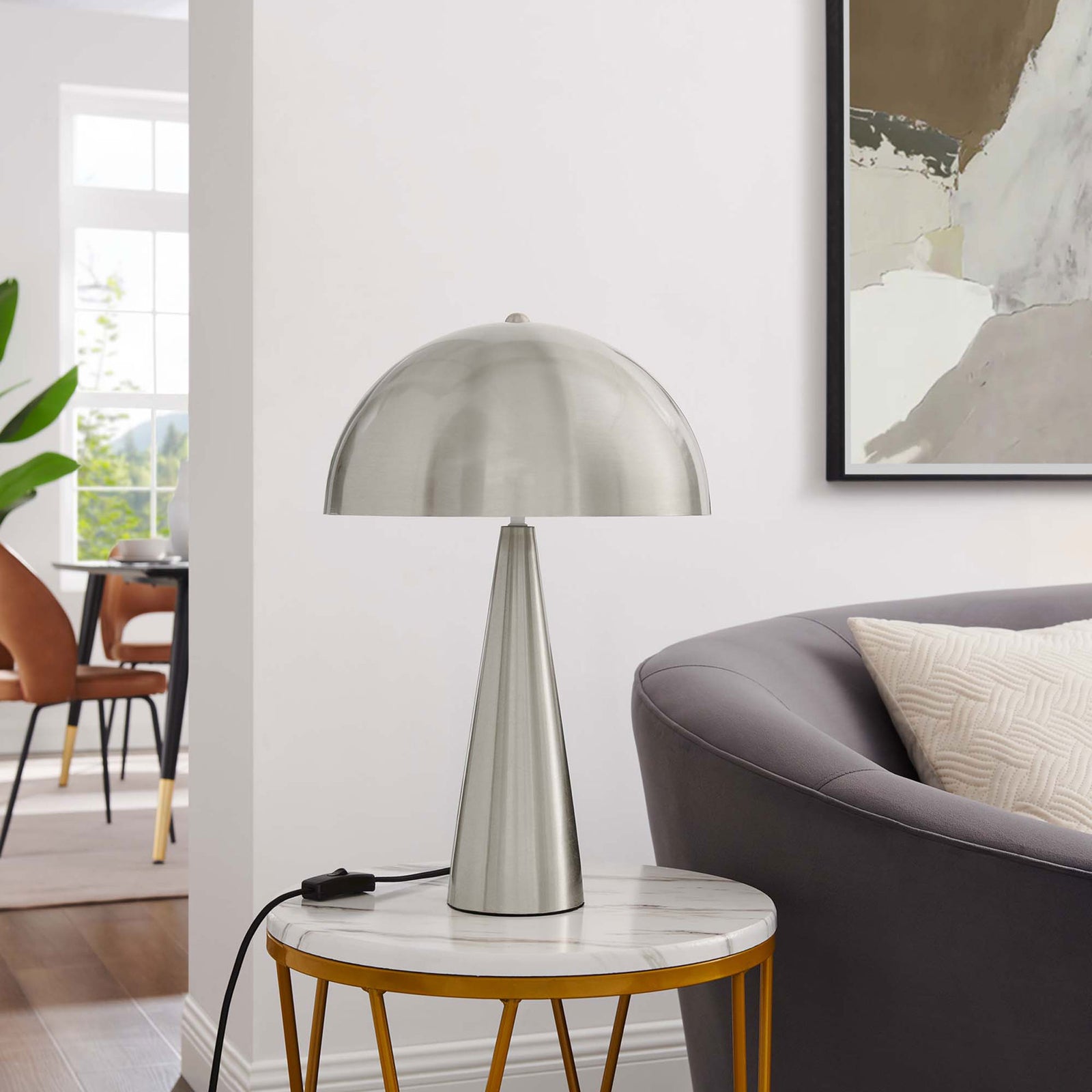 Satin nickel Selena lamp styled on a marble-topped side table beside a modern gray sofa || EEI-5624-SNL || front_room