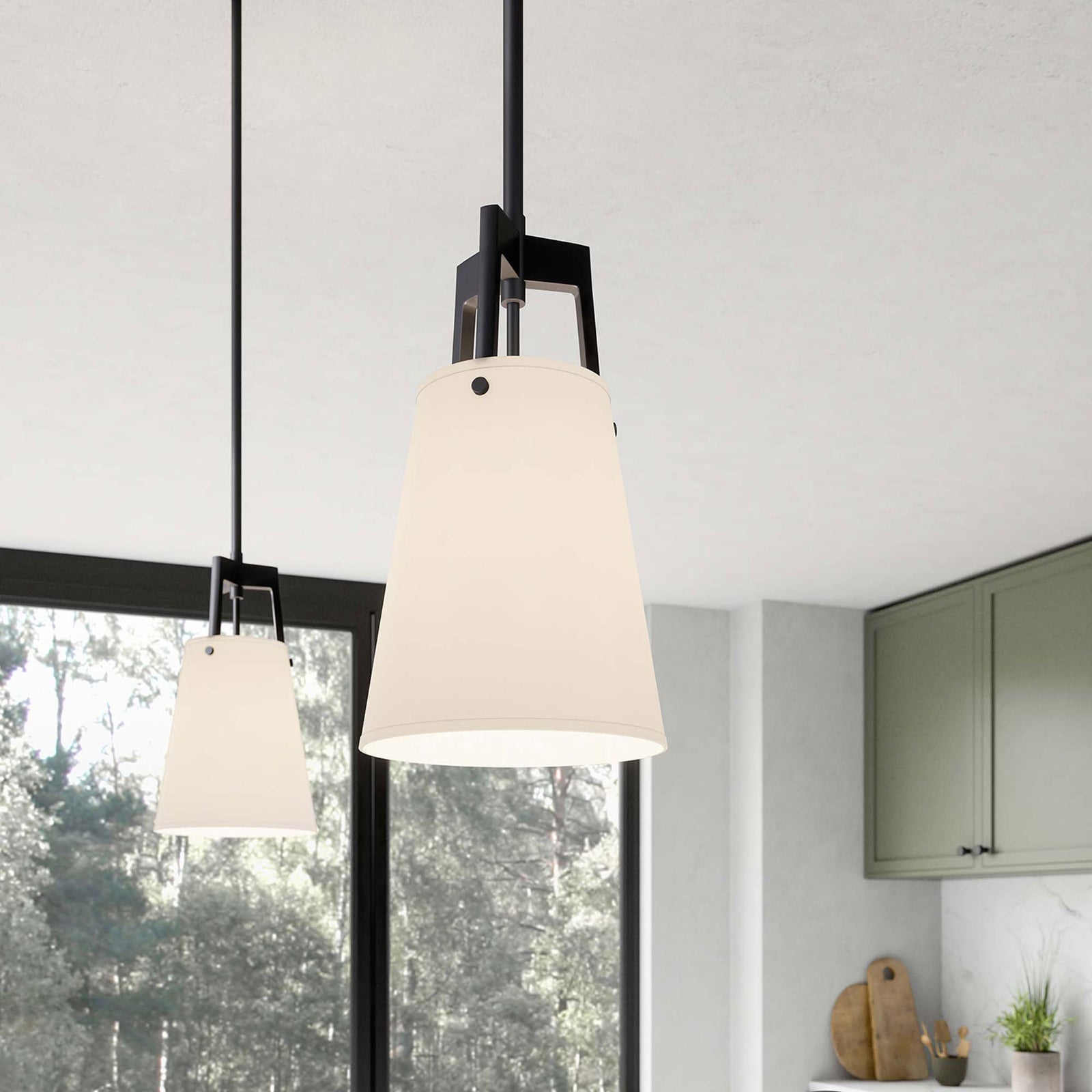 Warmly lit Aspire pendant illuminates a modern kitchen with soft glow through the white fabric shade || EEI-5639-WHI-BRZ || front_angle_on_room