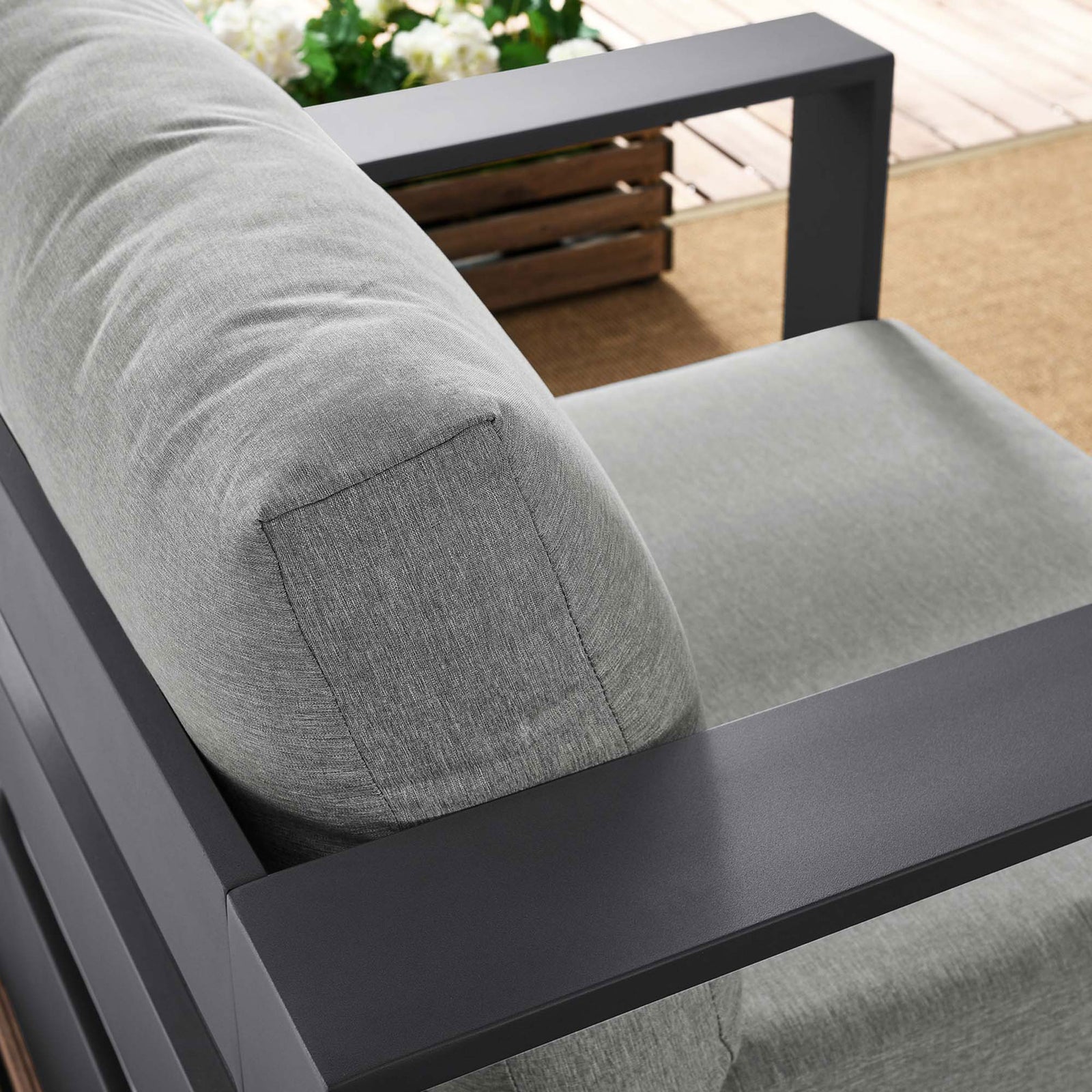 Tahoe armchair back cushion and armrest styled outdoors with textured light gray upholstery and dark frame || EEI-5675-GRY-GRY || detail_room