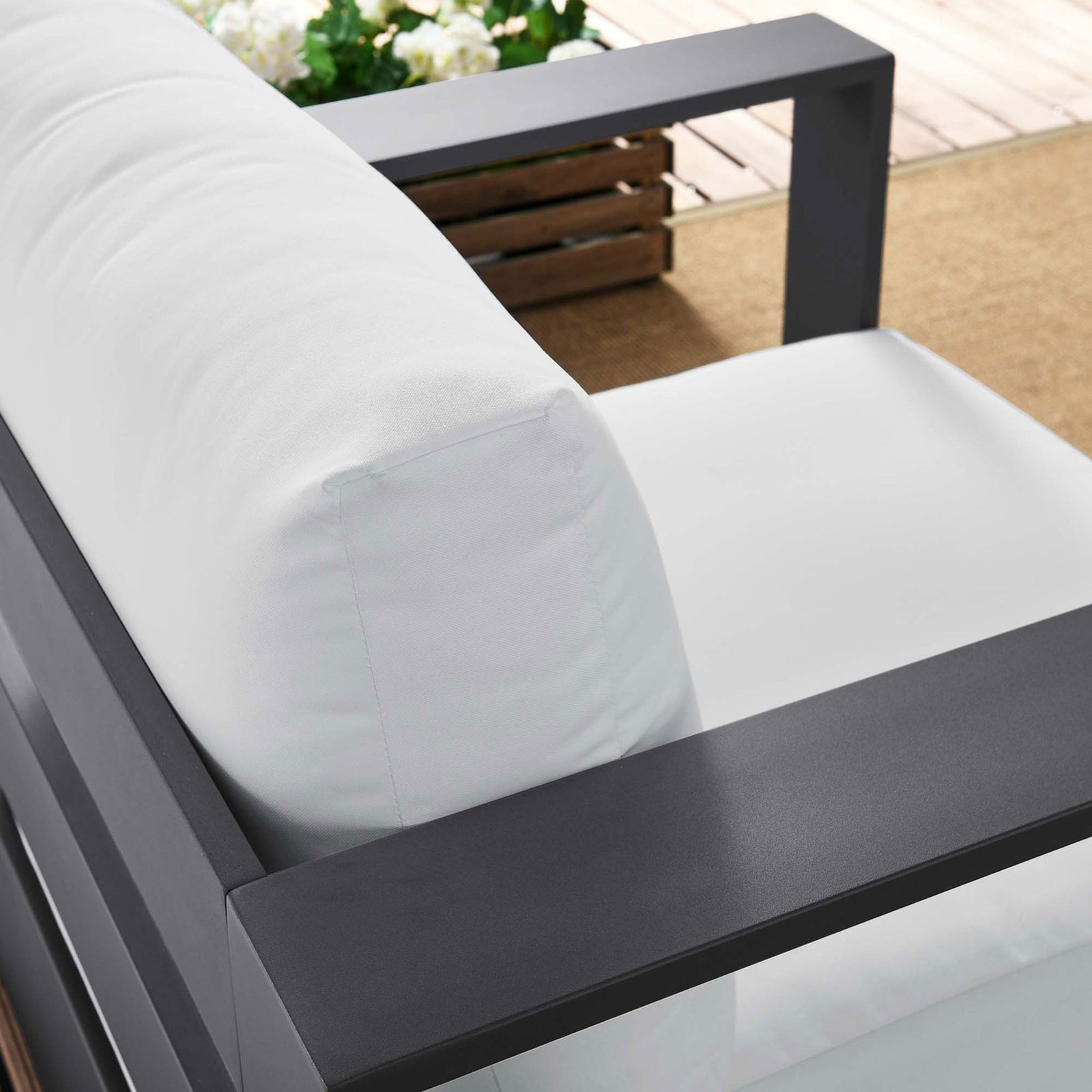 Tahoe armchair back cushion and armrest arranged outdoors with soft white upholstery and dark frame || EEI-5675-GRY-WHI || detail_room