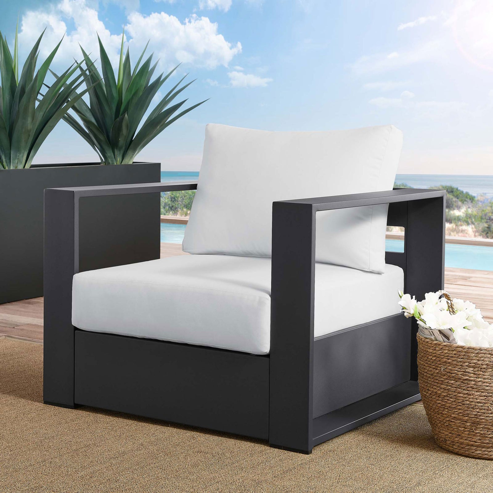 Tahoe charcoal aluminum outdoor armchair with white cushions styled on a modern poolside deck || EEI-5675-GRY-WHI || front_angle_room