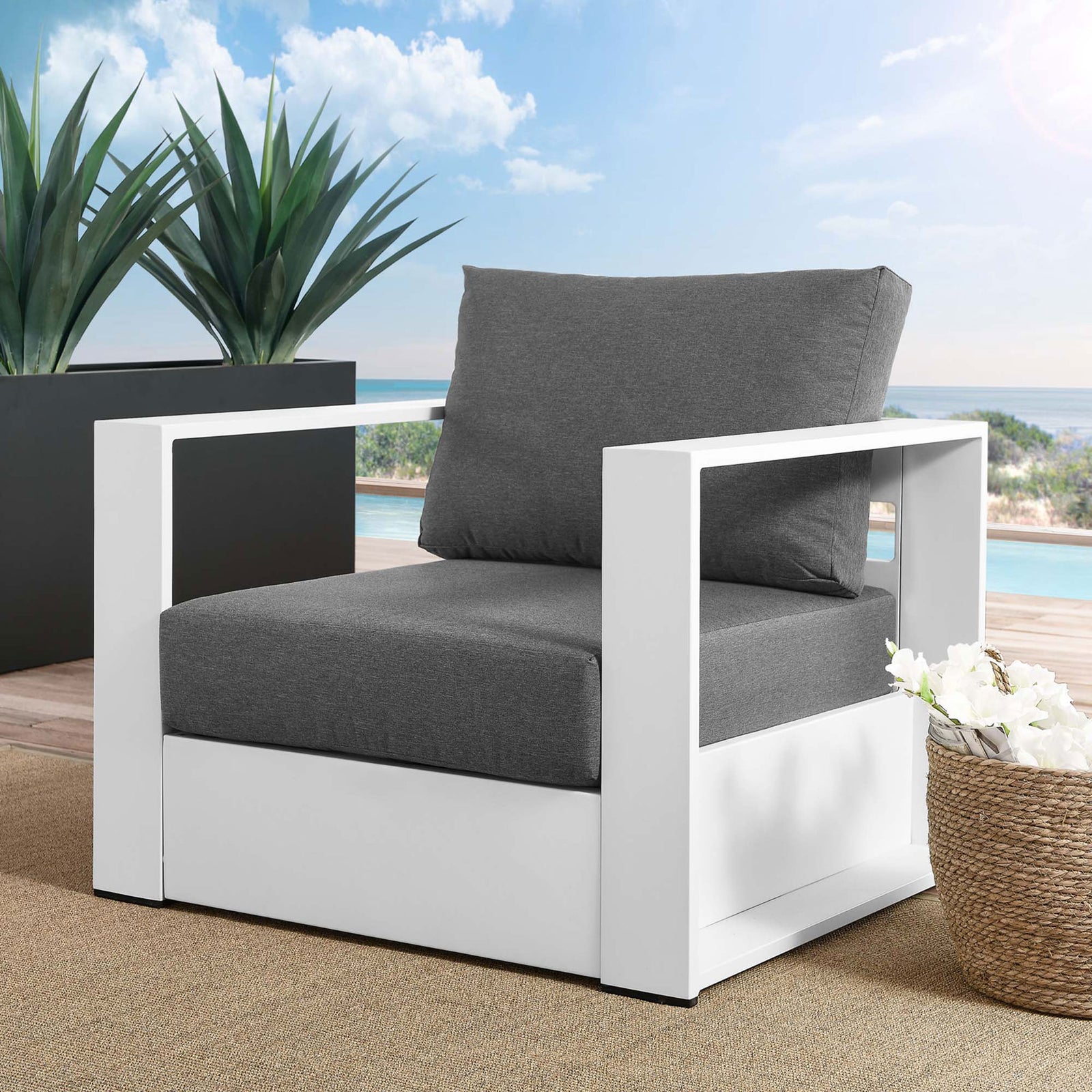 Tahoe white aluminum outdoor armchair with charcoal cushions styled on a modern poolside terrace || EEI-5675-WHI-CHA || front_angle_room