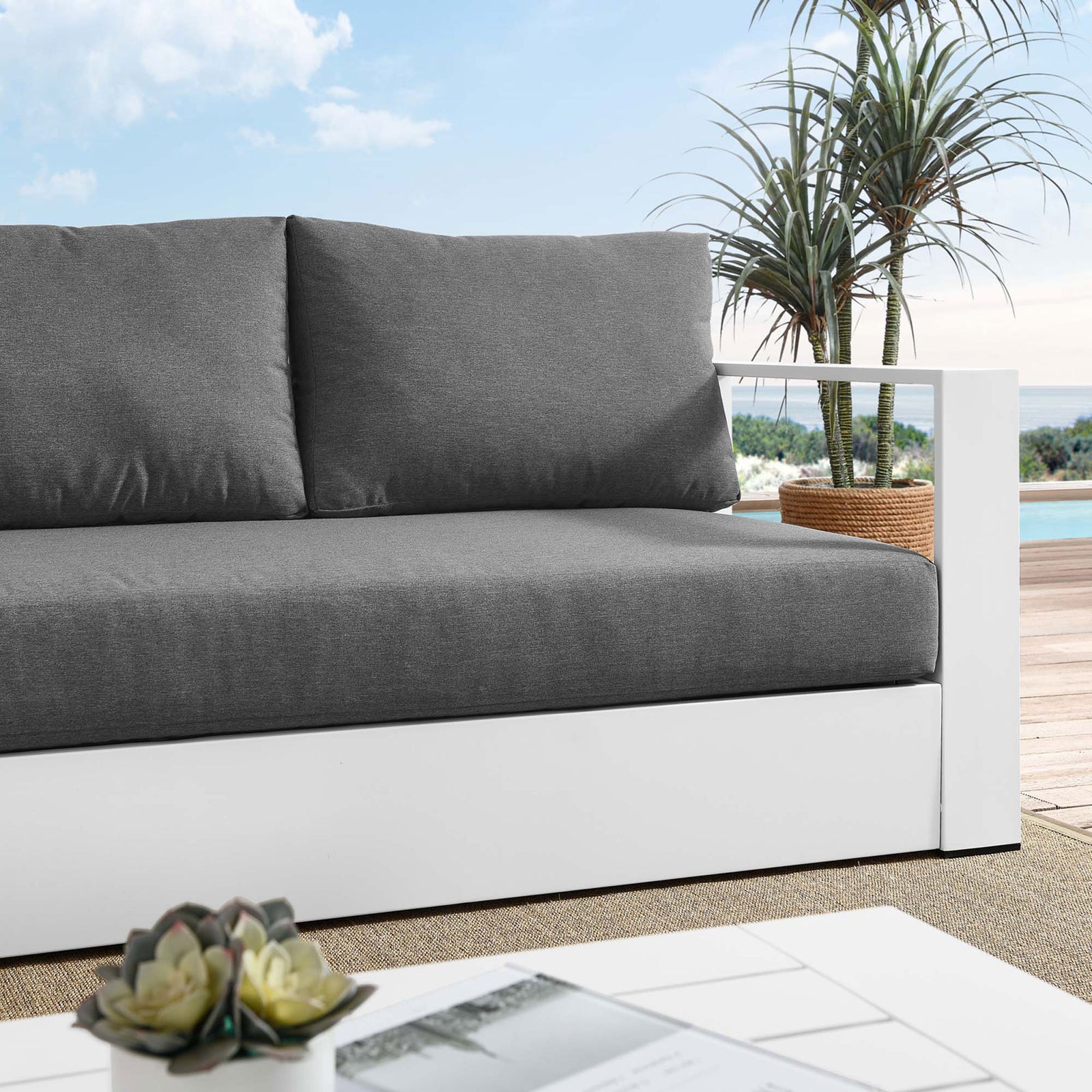 Close lifestyle view of the Tahoe sofa showing textured charcoal cushions against the white frame. || EEI-5676-WHI-CHA || detail_room