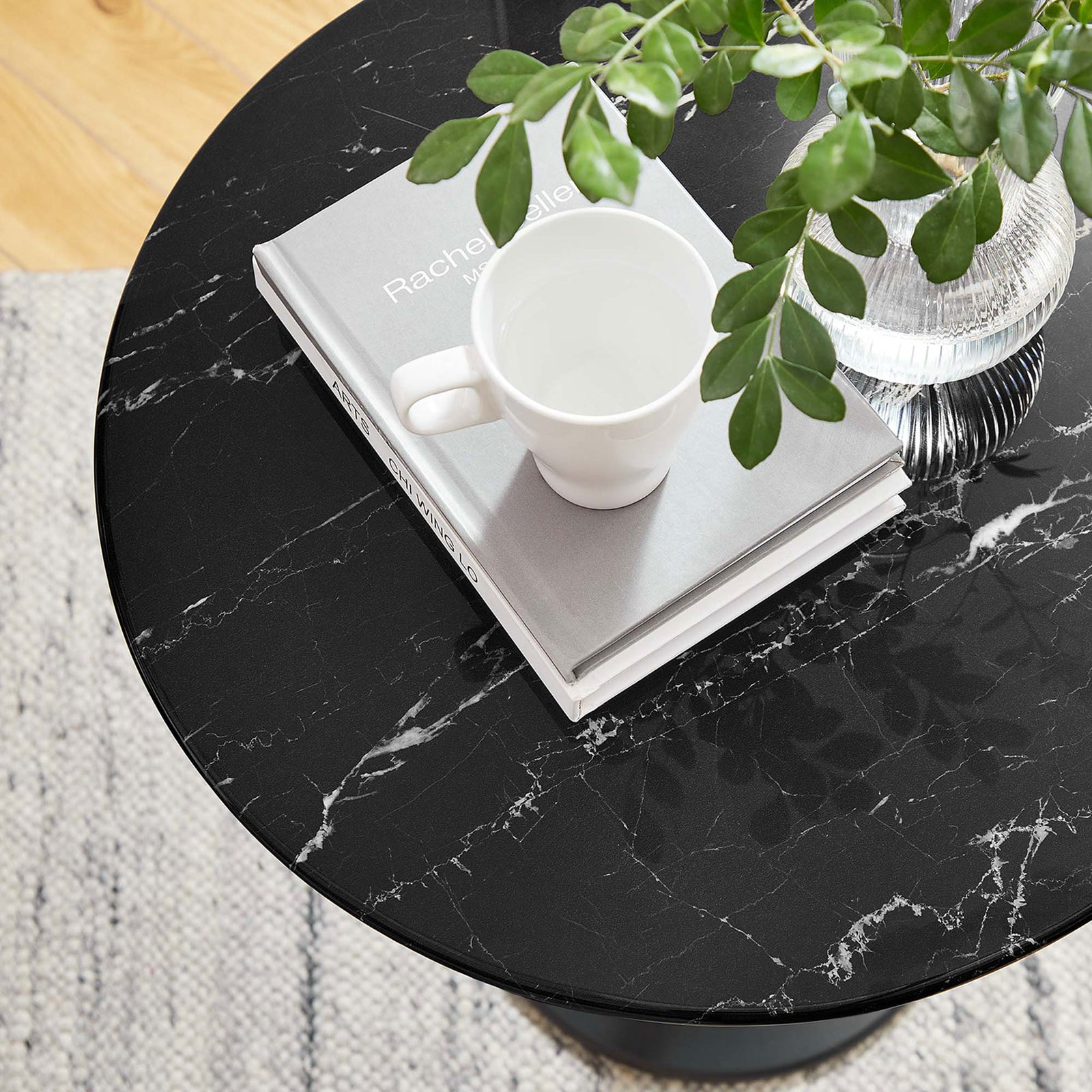 Black faux marble tabletop styled with book, mug, and greenery in a bright living space || EEI-5690-BLK-BLK || detail_room