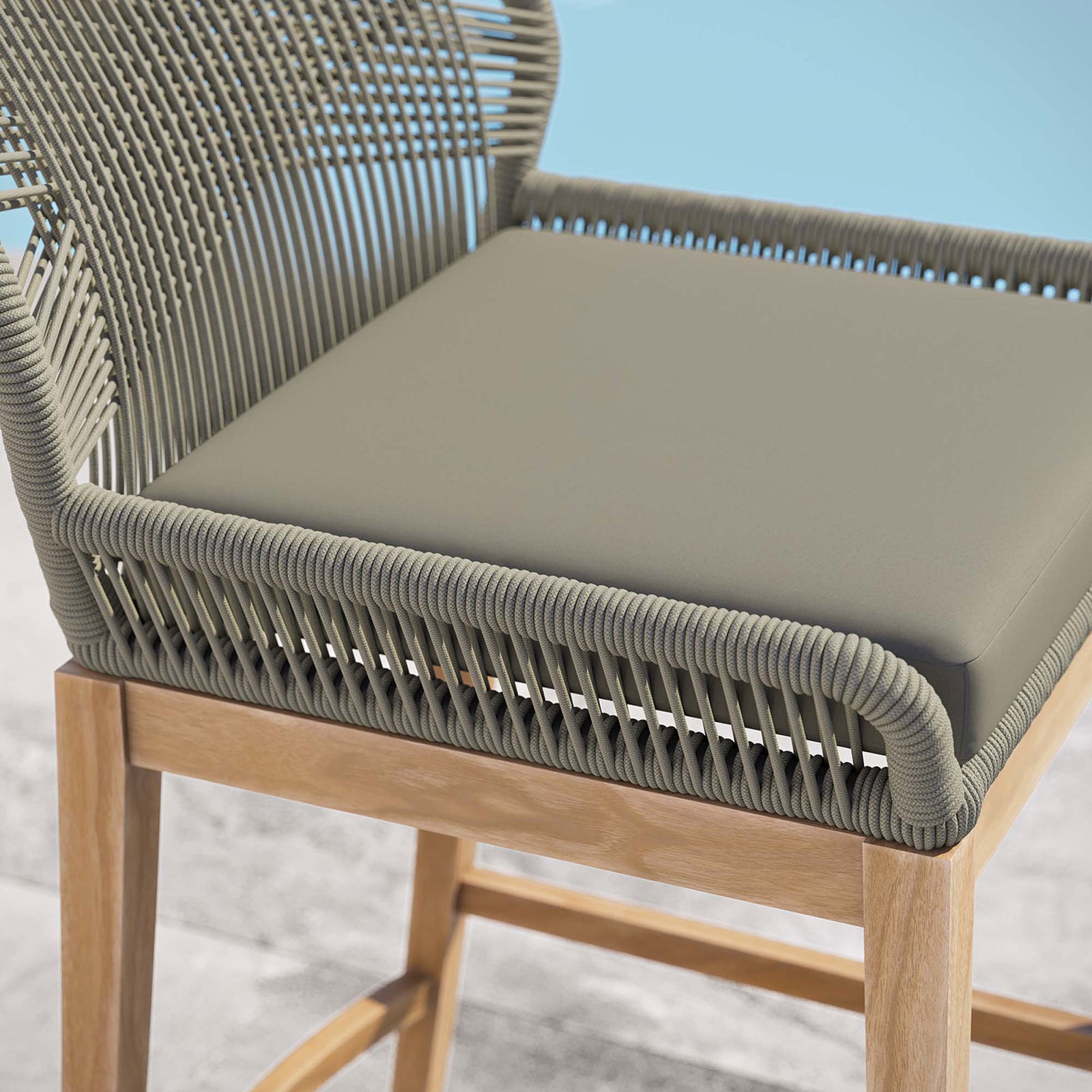 Smooth light greige cushion and tightly wrapped rope frame on the Wellspring bar stool overlooking the water. || EEI-5746-LGR-GRG || detail_room