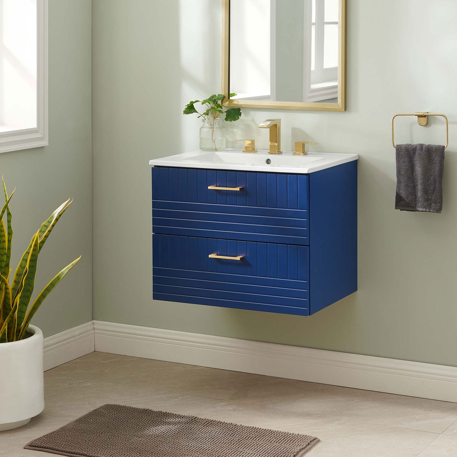 Clean-lined blue vanity floats beautifully in a modern bath, finished with gold accents || EEI-5818-BLU-WHI || front_angle_room