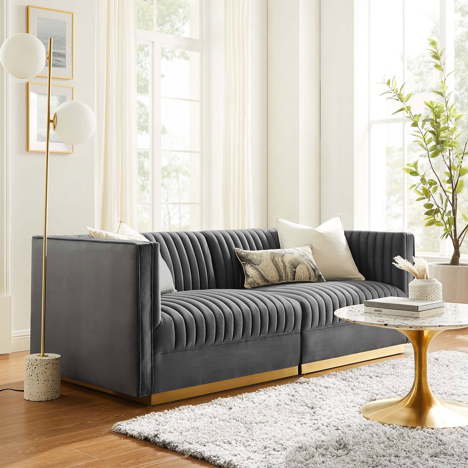 Gray velvet channel-tufted loveseat with gold base anchored by modern decor for an inviting lounge setting || EEI-5824-GRY || front_angle_room