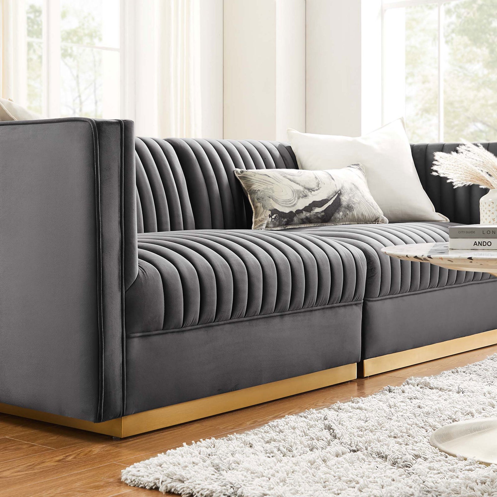 Gray channel-tufted velvet loveseat with gold base styled with plush pillows in a bright contemporary living space || EEI-5824-GRY || detail_room
