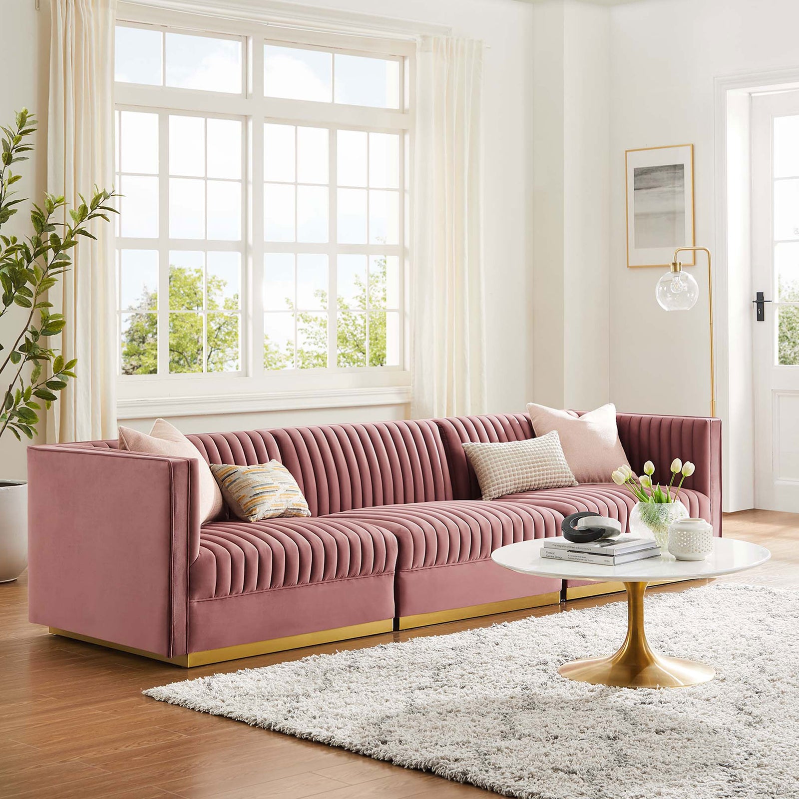 Modern dusty rose velvet sectional with channel tufting and gold base completing a light airy living room || EEI-5825-DUS || front_angle_room