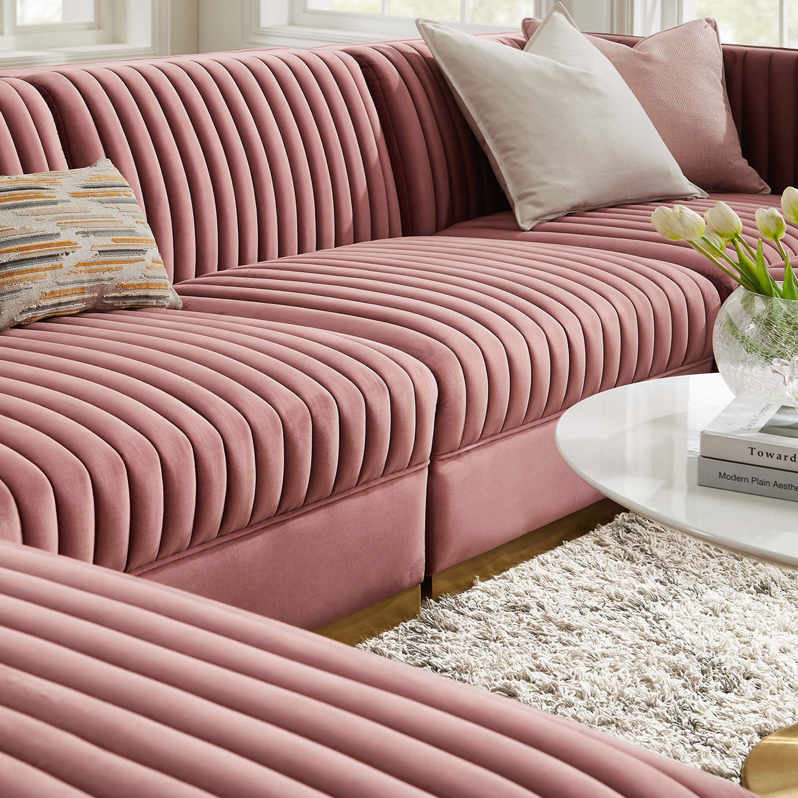 Soft performance velvet seating layered with pillows and decor for a cozy modern lounging space || EEI-5841-DUS || detail_room