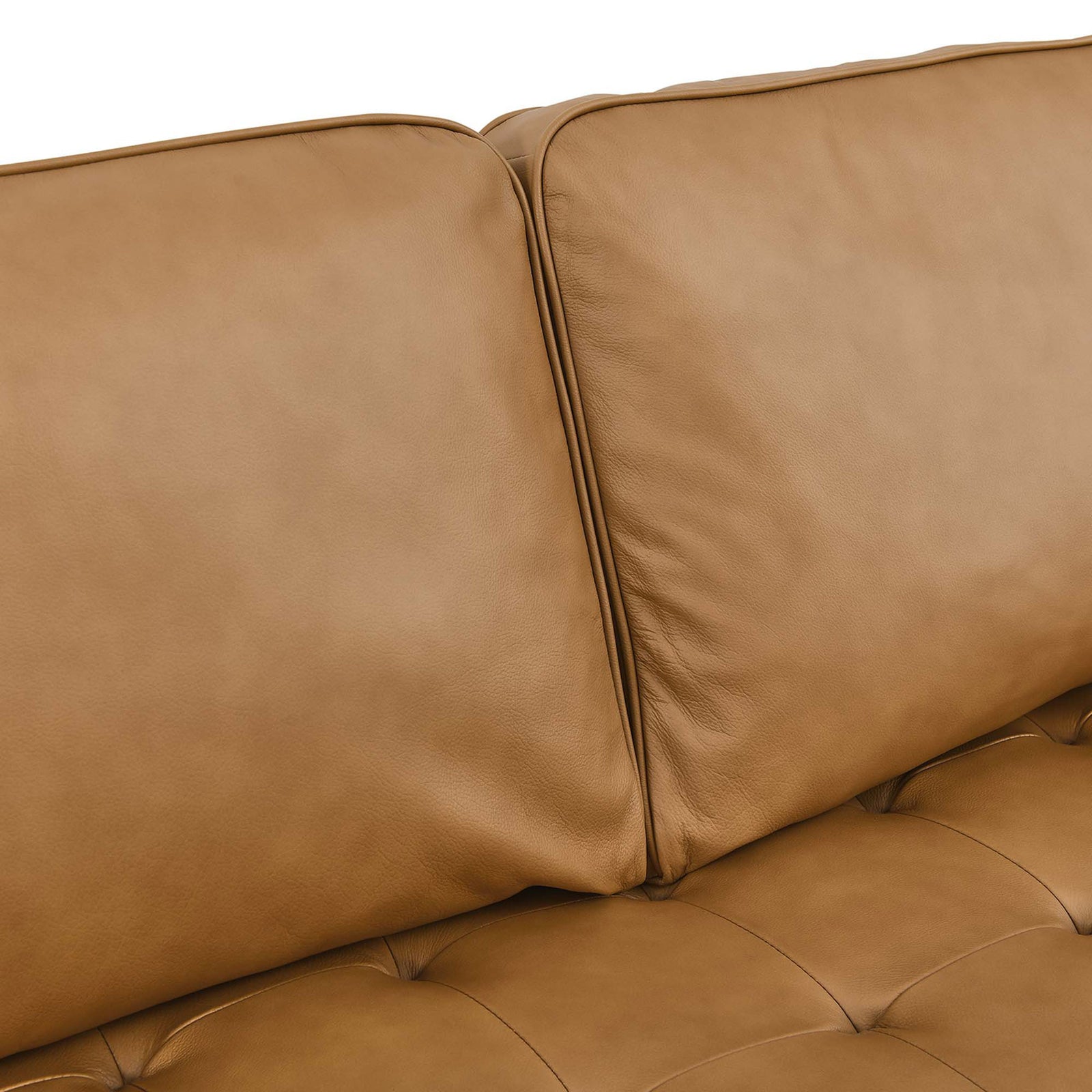Soft tan leather cushions with subtle grain and biscuit tufting for a refined, comfortable seating surface. || EEI-5873-TAN || detail_studio