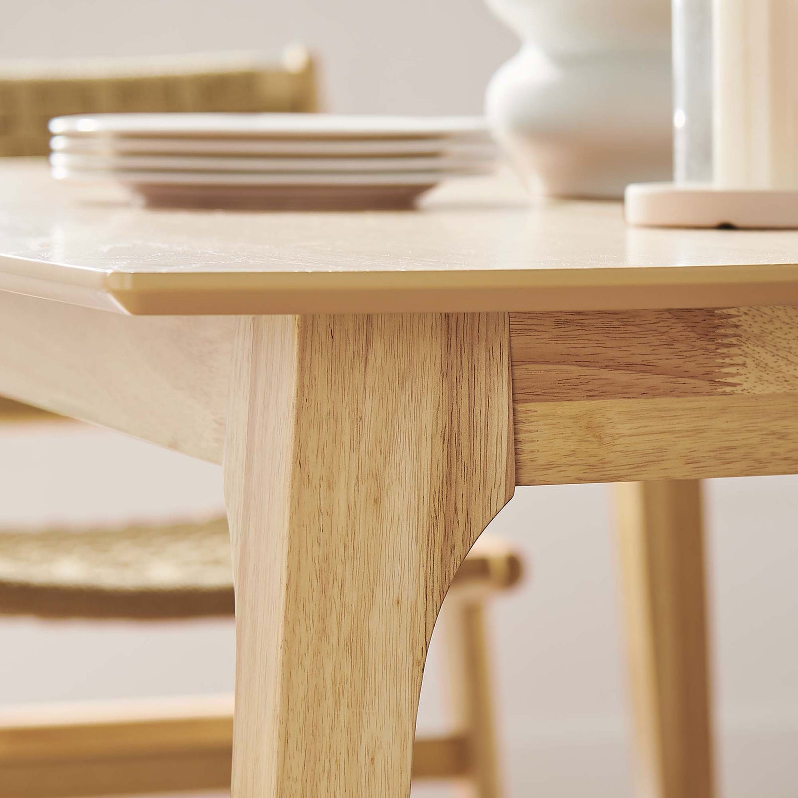 Detail of oak dining table edge and leg showcasing warm finish and smooth craftsmanship || EEI-6017-OAK-OAK || detail_room