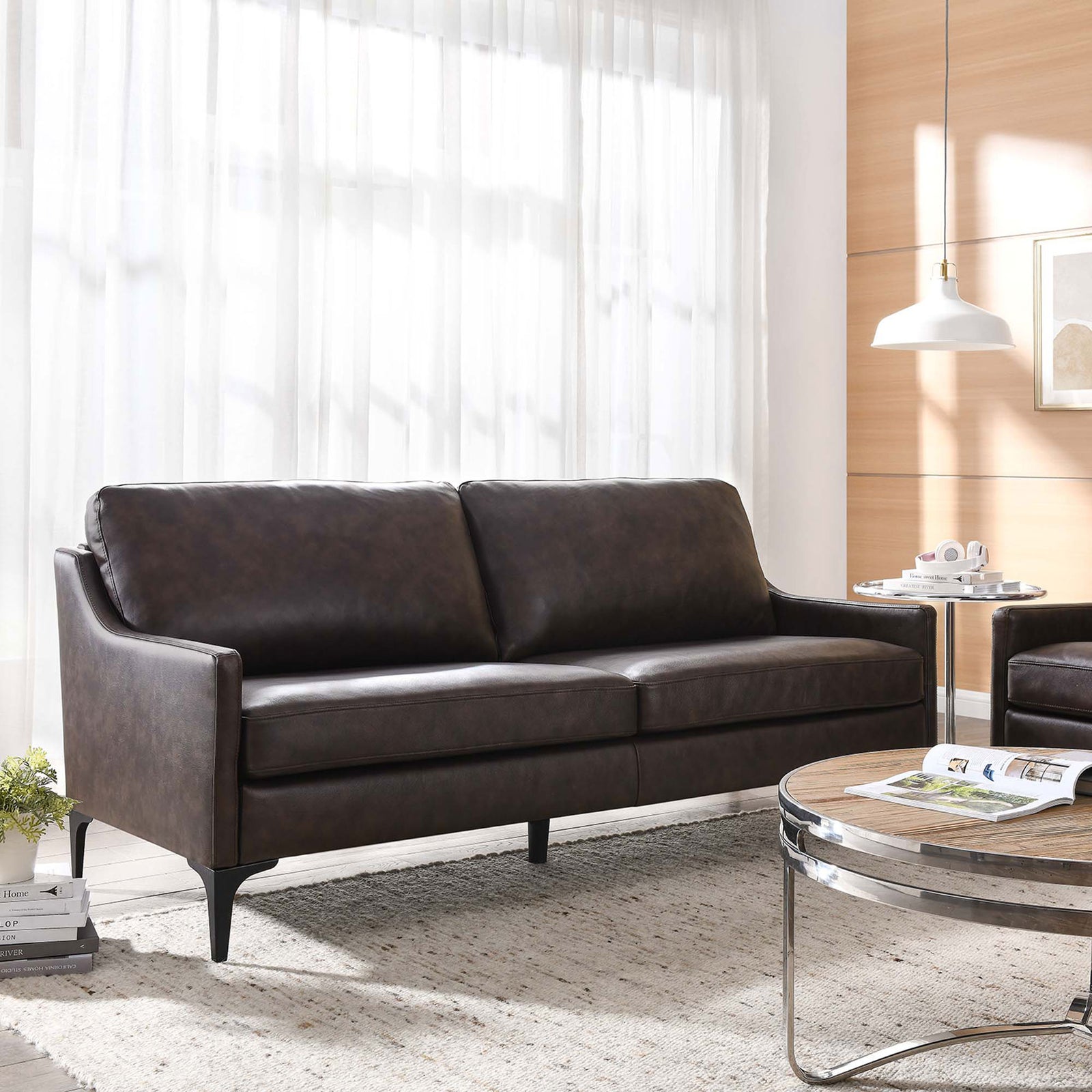 Brown leather sofa anchored in a sunlit living room with rug and coffee table, creating a warm, contemporary retreat || EEI-6018-BRN || front_angle_room