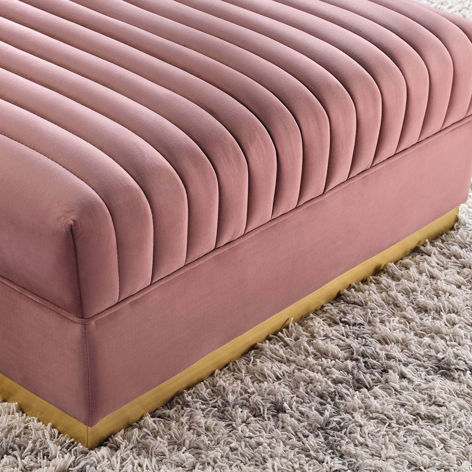 Textured shag rug frames the dusty rose ottoman, accentuating its gold base and soft channel tufting || EEI-6036-DUS || detail_room