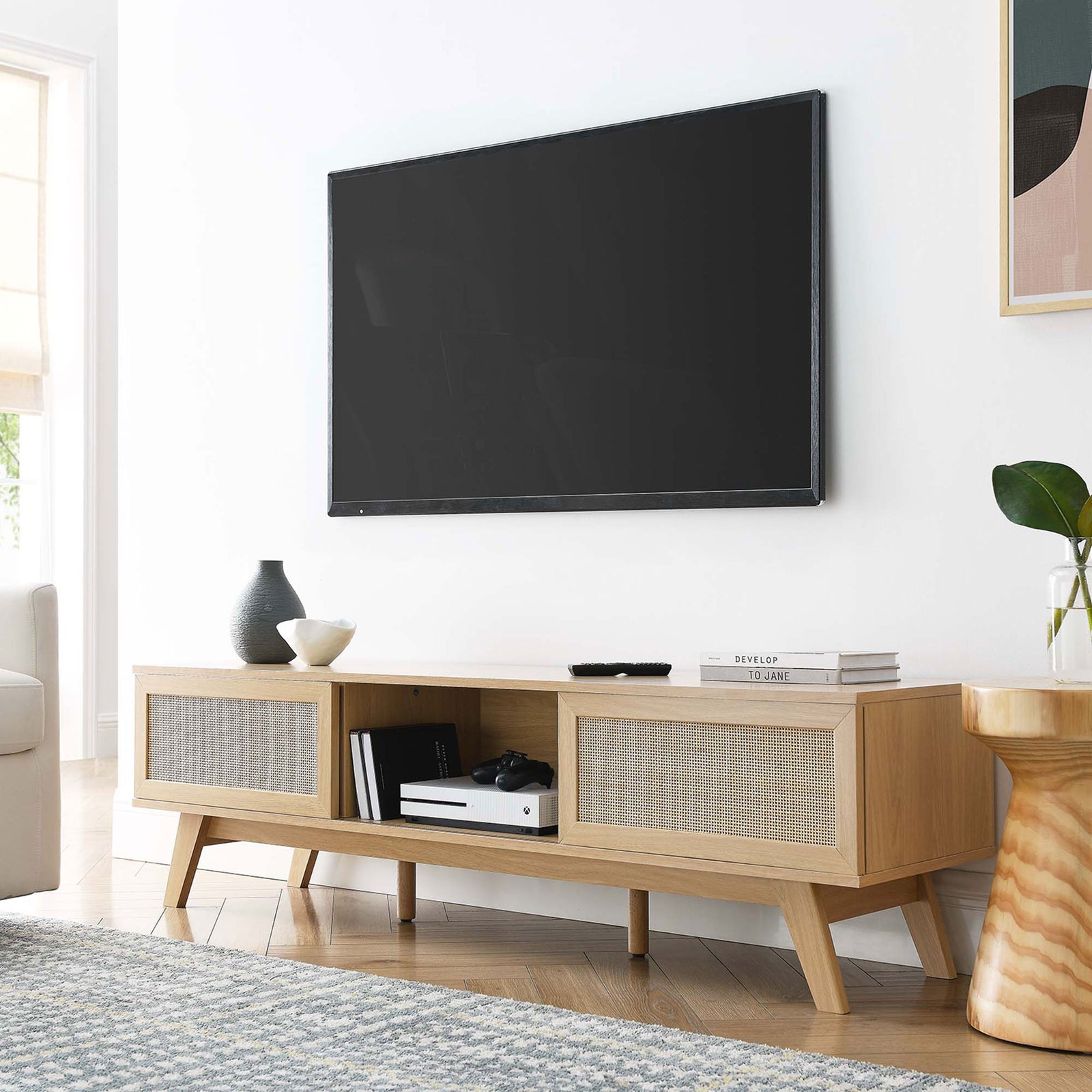 Oak tv stand with dual rattan doors and open shelf styled beneath a wall-mounted tv || EEI-6040-OAK || front_angle_room