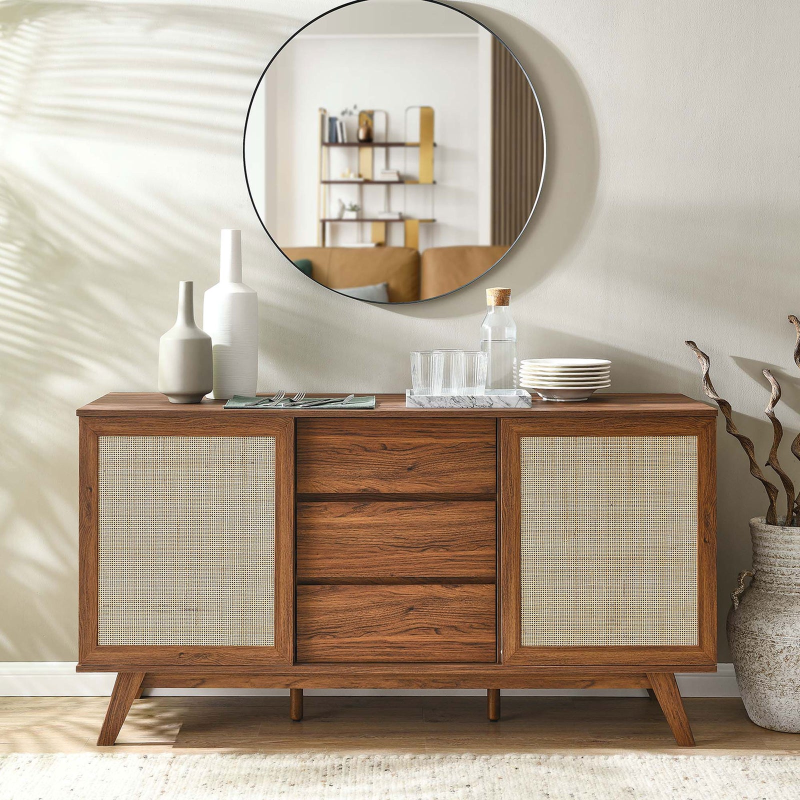 Walnut rattan sideboard styled with barware and decor as a sophisticated console in a bright room || EEI-6043-WAL || front_angle_room