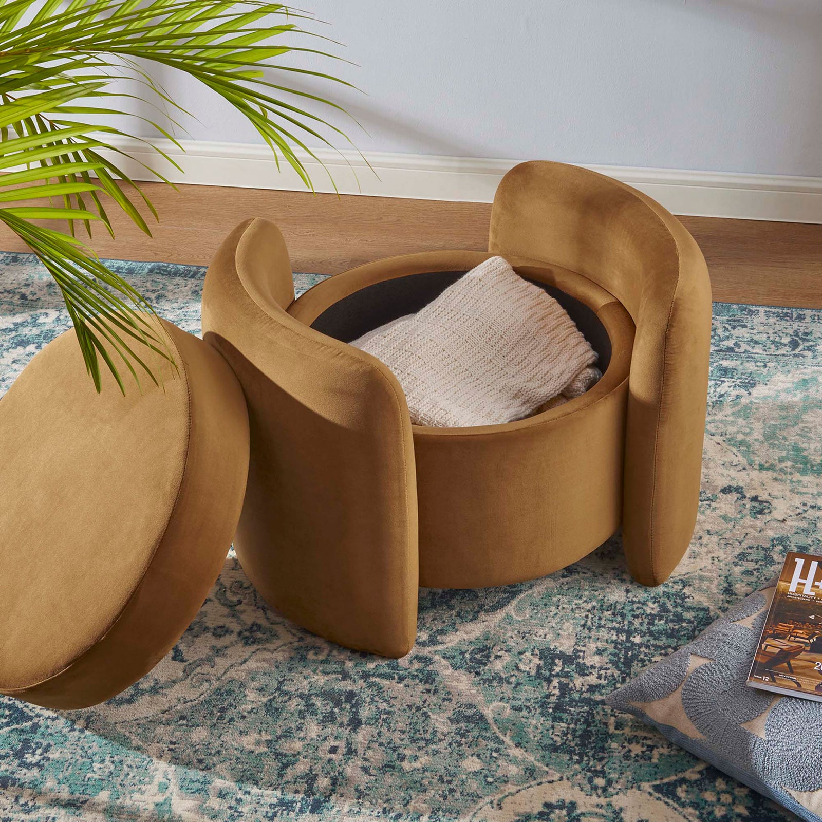 Cognac velvet storage ottoman styled in a living room with its lid off to reveal a blanket tucked inside || EEI-6055-COG || front_angle_open_room