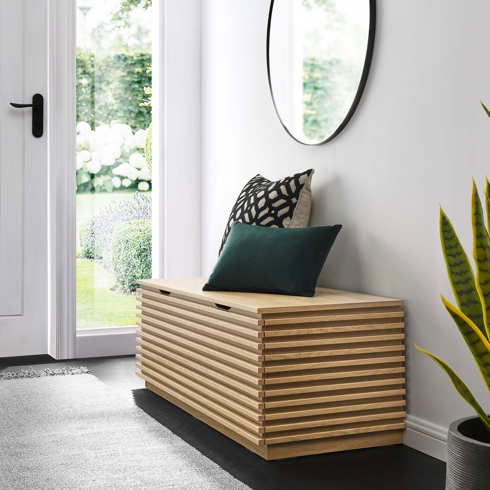 Versatile entryway bench in oak with slatted design, ideal for seating and concealed storage. || EEI-6057-OAK || front_angle_room