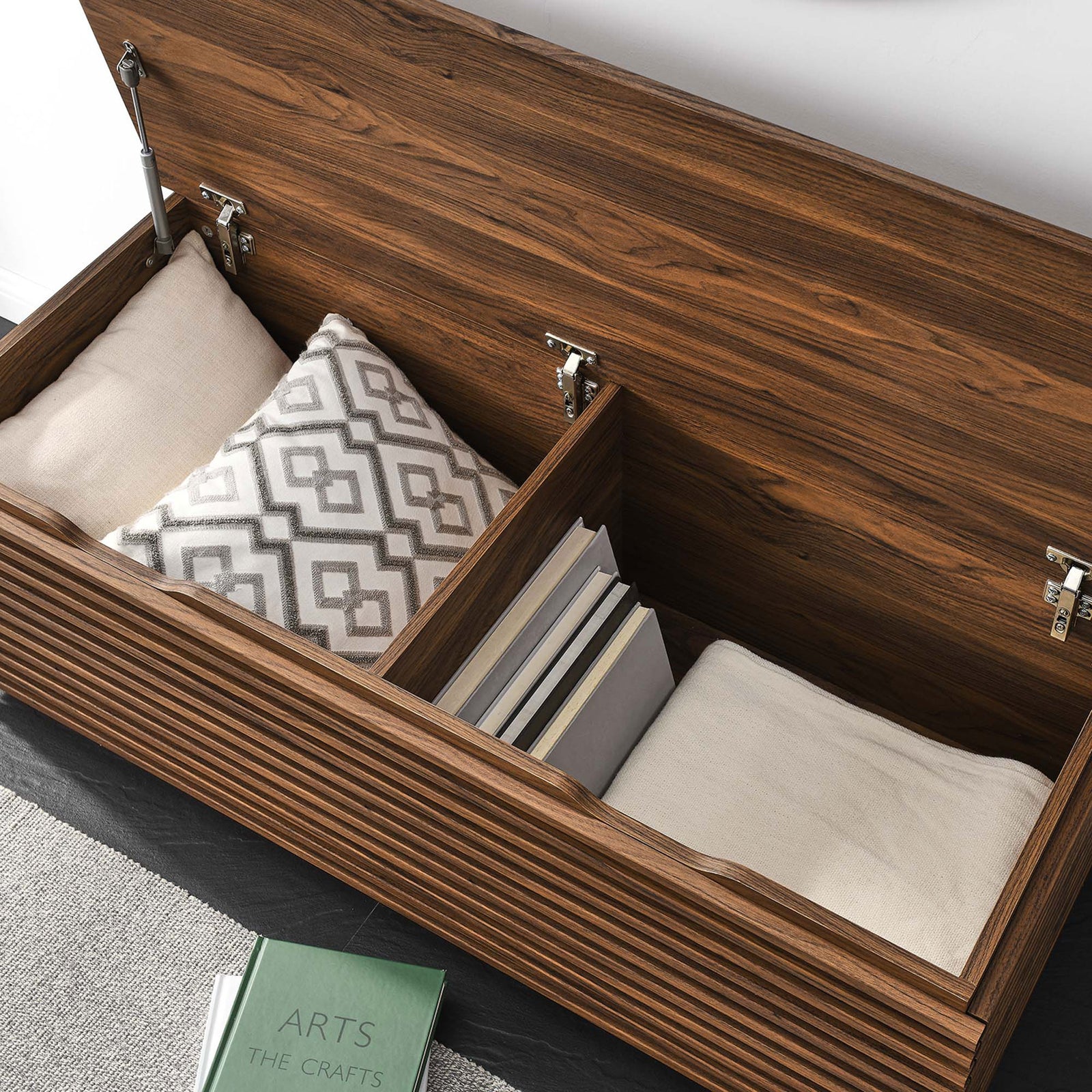 Generous storage keeps pillows, throws, and books neatly organized || EEI-6057-WAL || storage_open_room